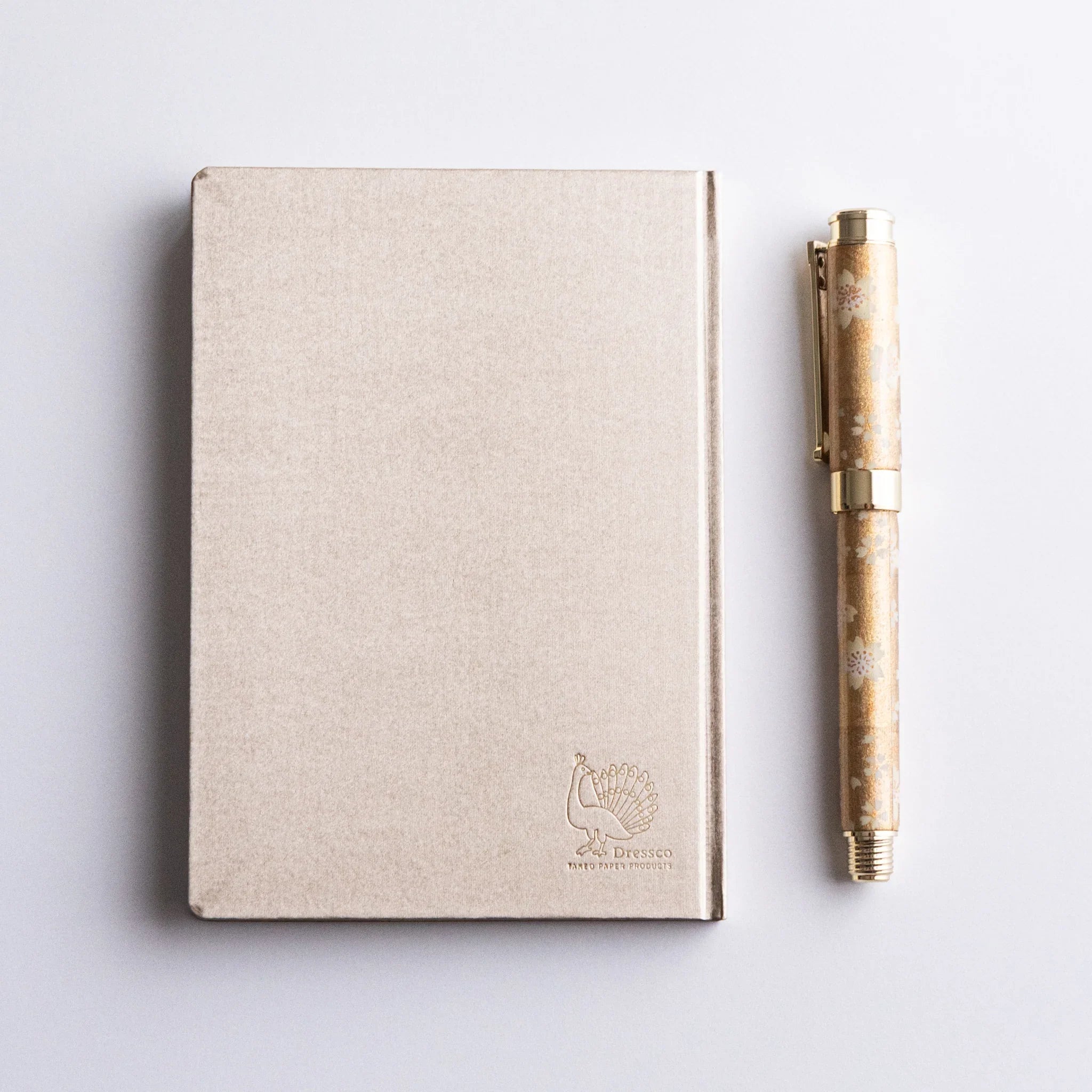 Flat lay of Dressco Bank Ledger Paper A6 notebook showing front cover and A6 dimensions from a top-down view