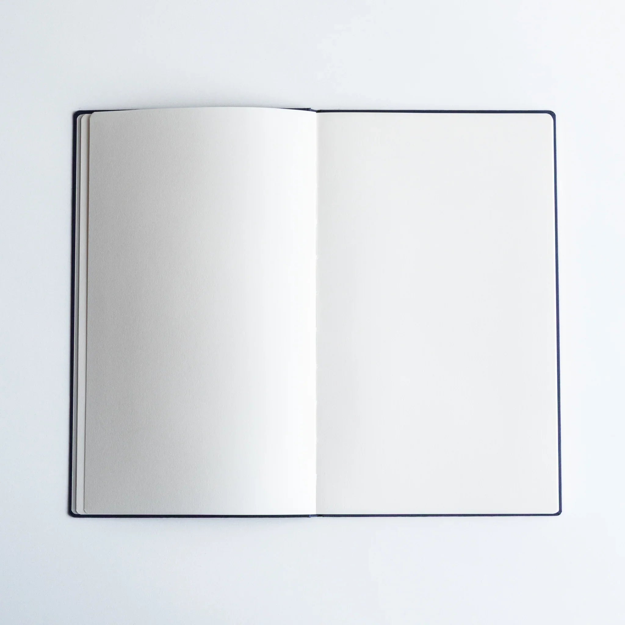 Dressco bank ledger paper A6 notebook, angled three-quarter view showing texture and cover design, Dressco Japanese bank