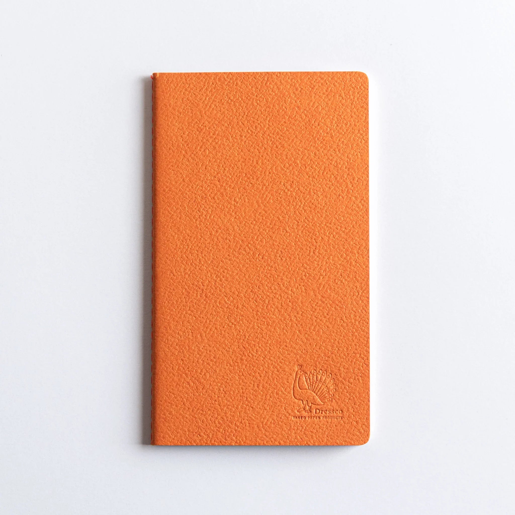 Charcoal A6 Dressco stitched notebook opened showing white interior pages with horizontal line ruled bank ledger style