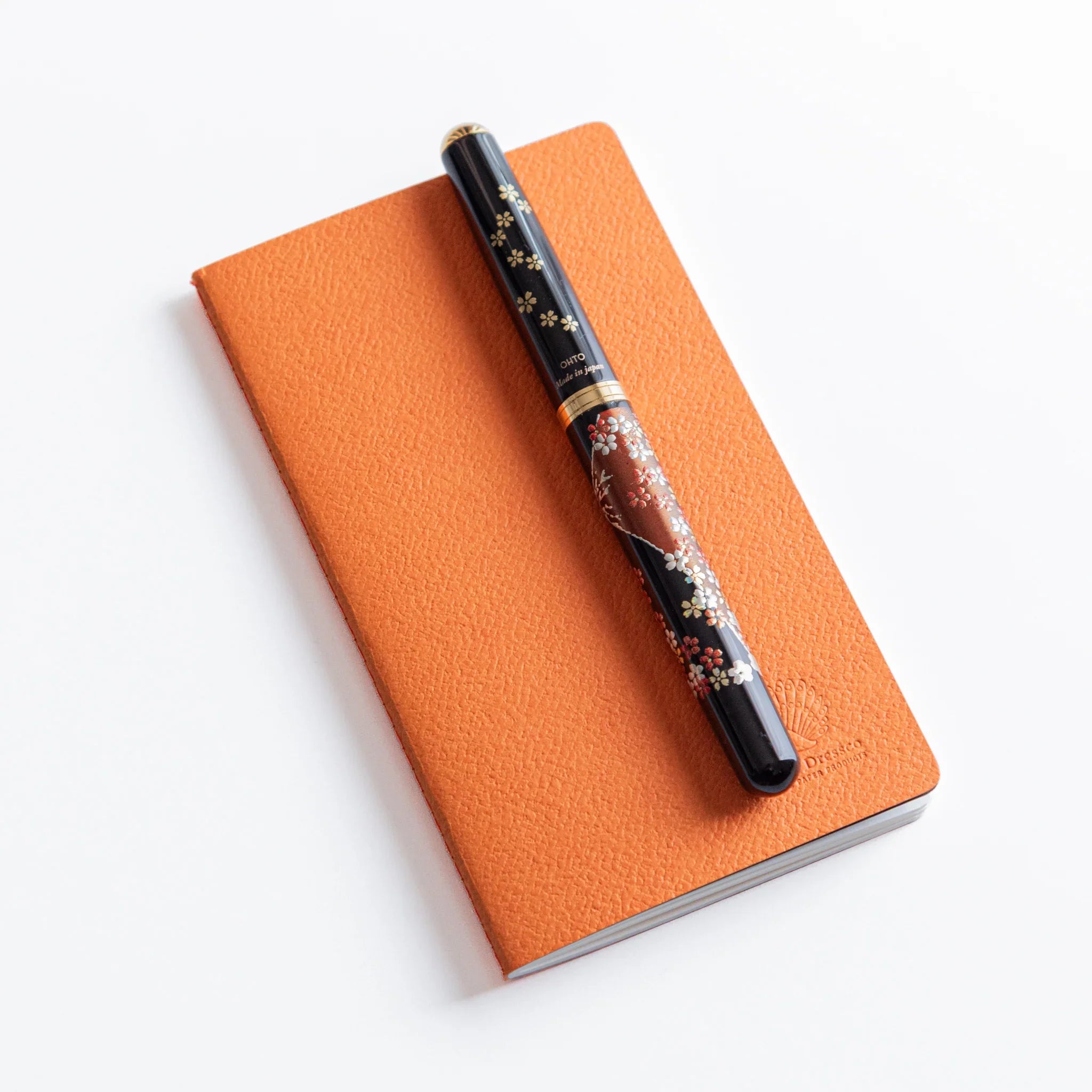 Open spread of Dressco A6 notebook displaying alternating blank pages and lined pages in cream colored paper stock