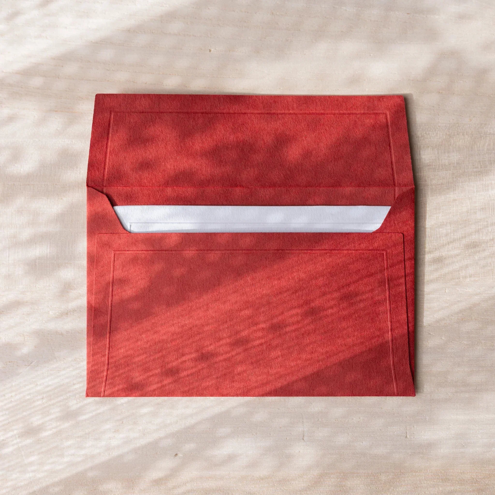 Dressco envelope, teal shade, flat lay displaying surface texture composition                                 