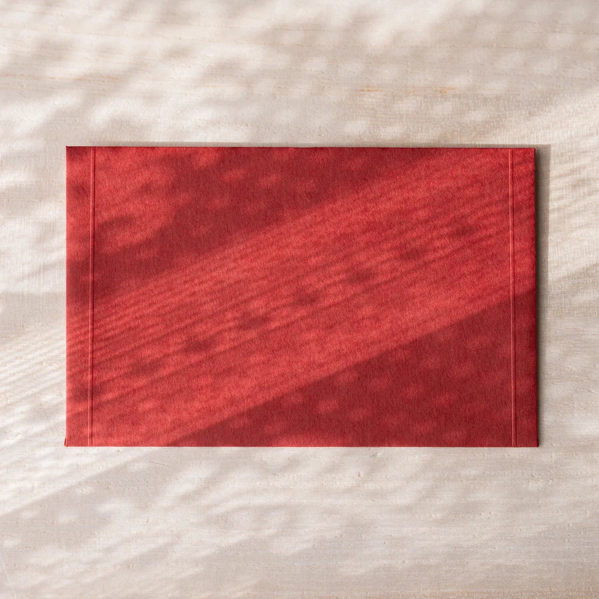 Dressco envelope set, teal tone, angled view highlighting embossed detail                                     