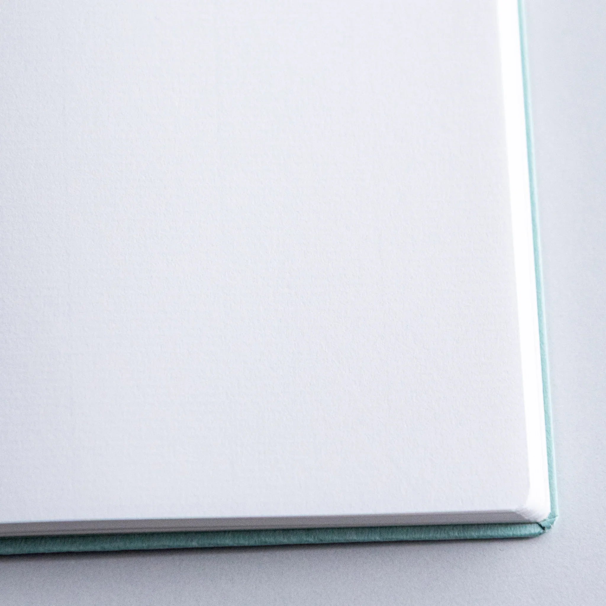 Detailed close-up of Dressco Spica Laid Bond Paper A6 notebook cover showing the laid texture pattern and paper grain