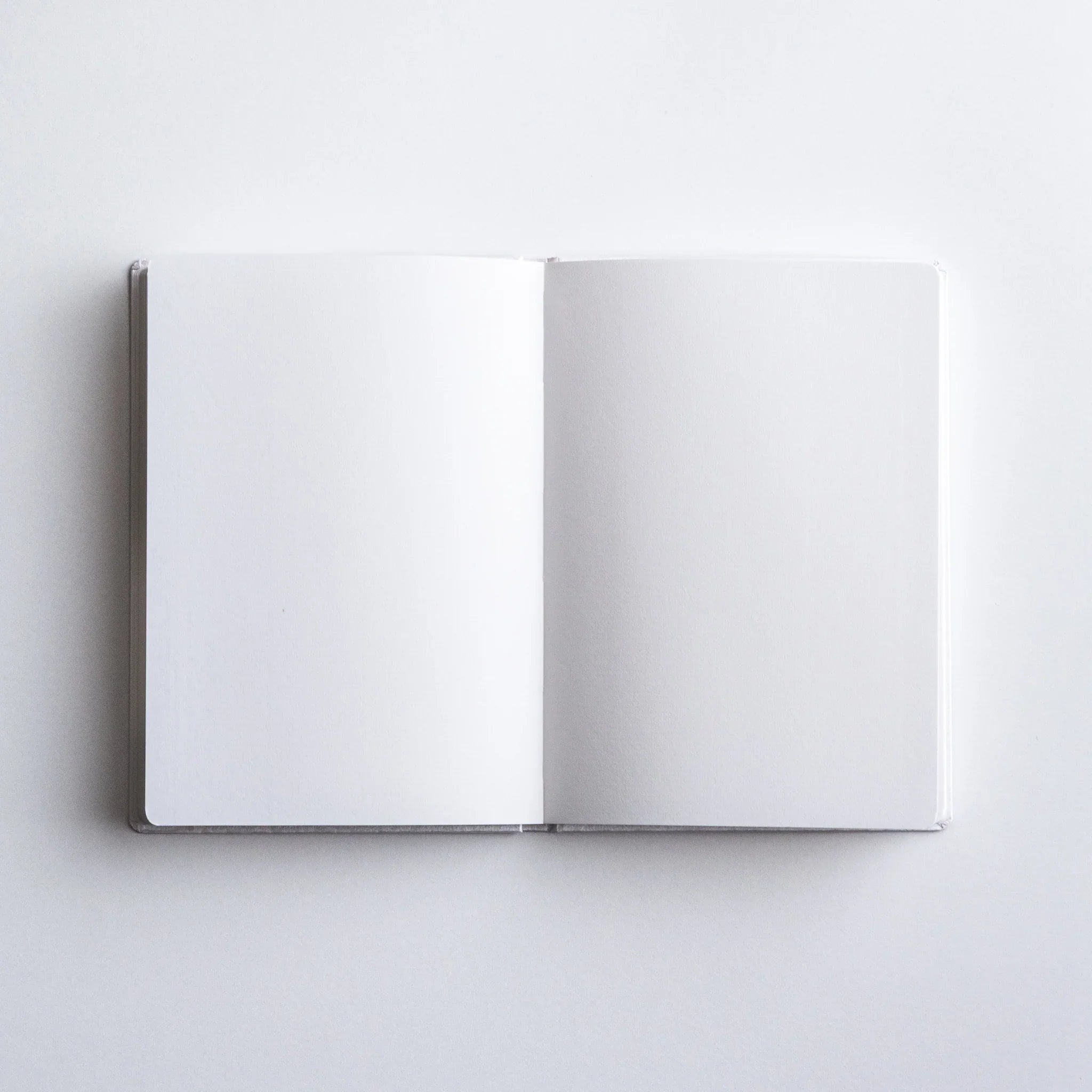 Close-up of Dressco Spica Laid Bond Paper A6 notebook showing the cover detail and laid bond paper edge texture