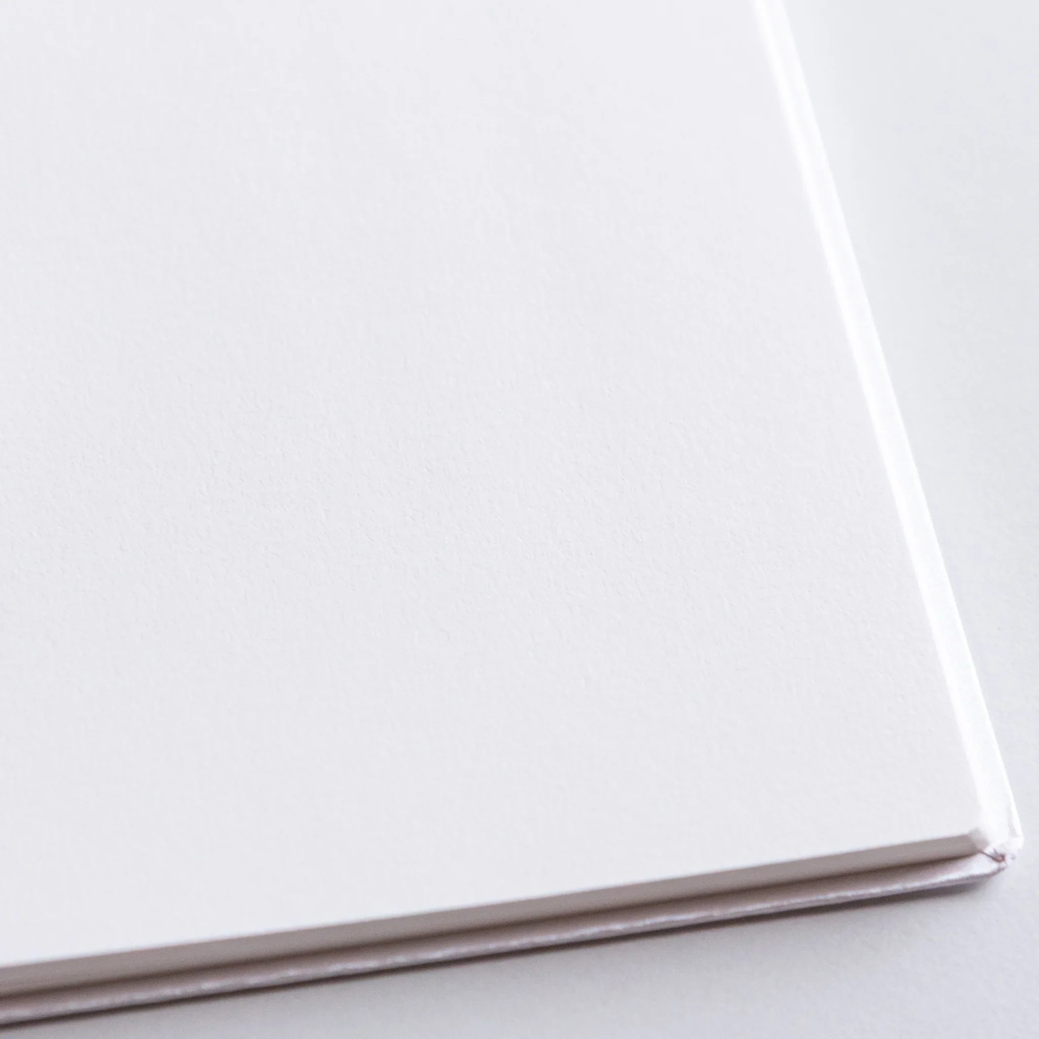 Dressco Spica Laid Bond Paper B6 notebook second variant at angle showing the laid bond paper and binding edge