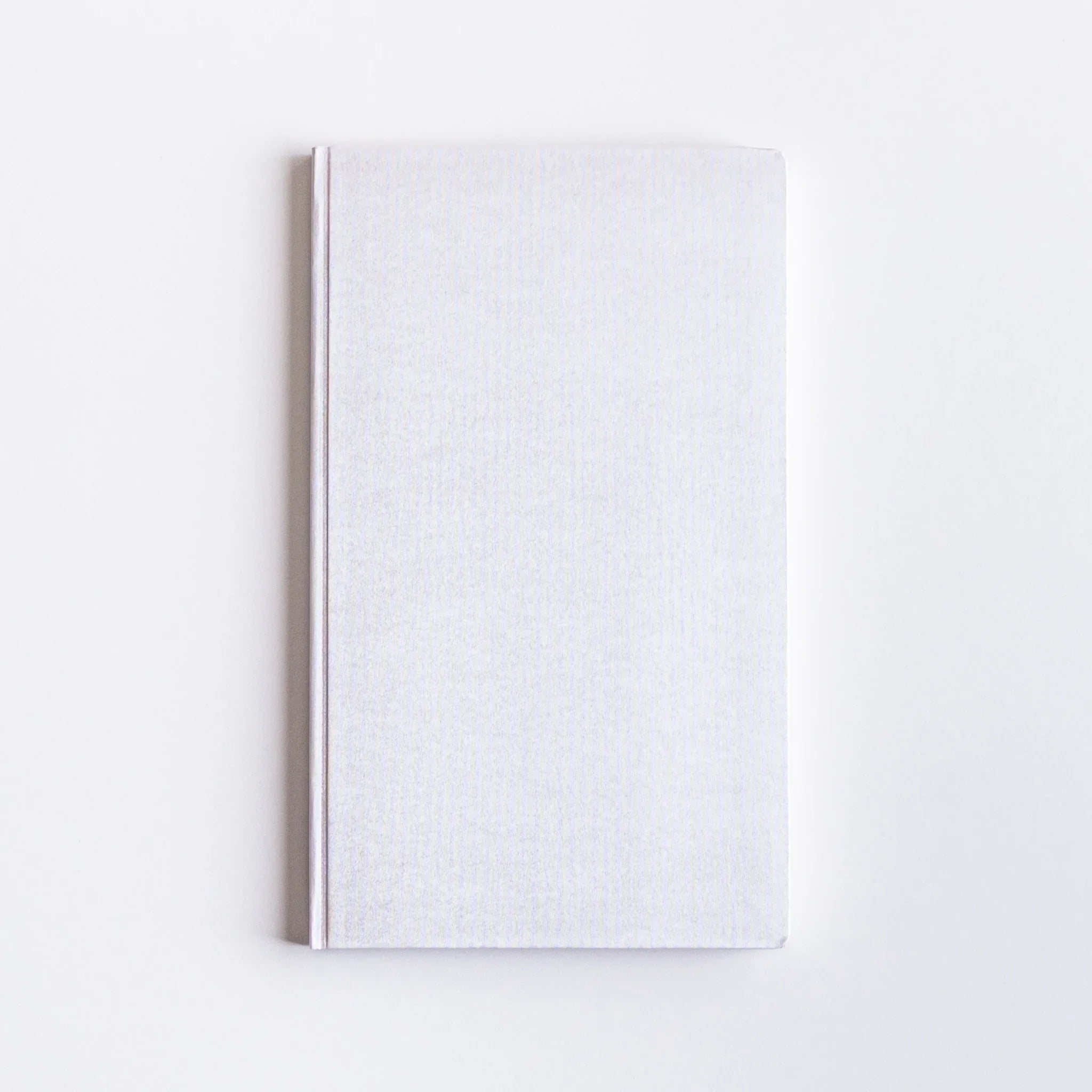 Flat lay overhead of Dressco Spica Laid Bond Paper B6 notebook second variant showing cover and B6 proportions