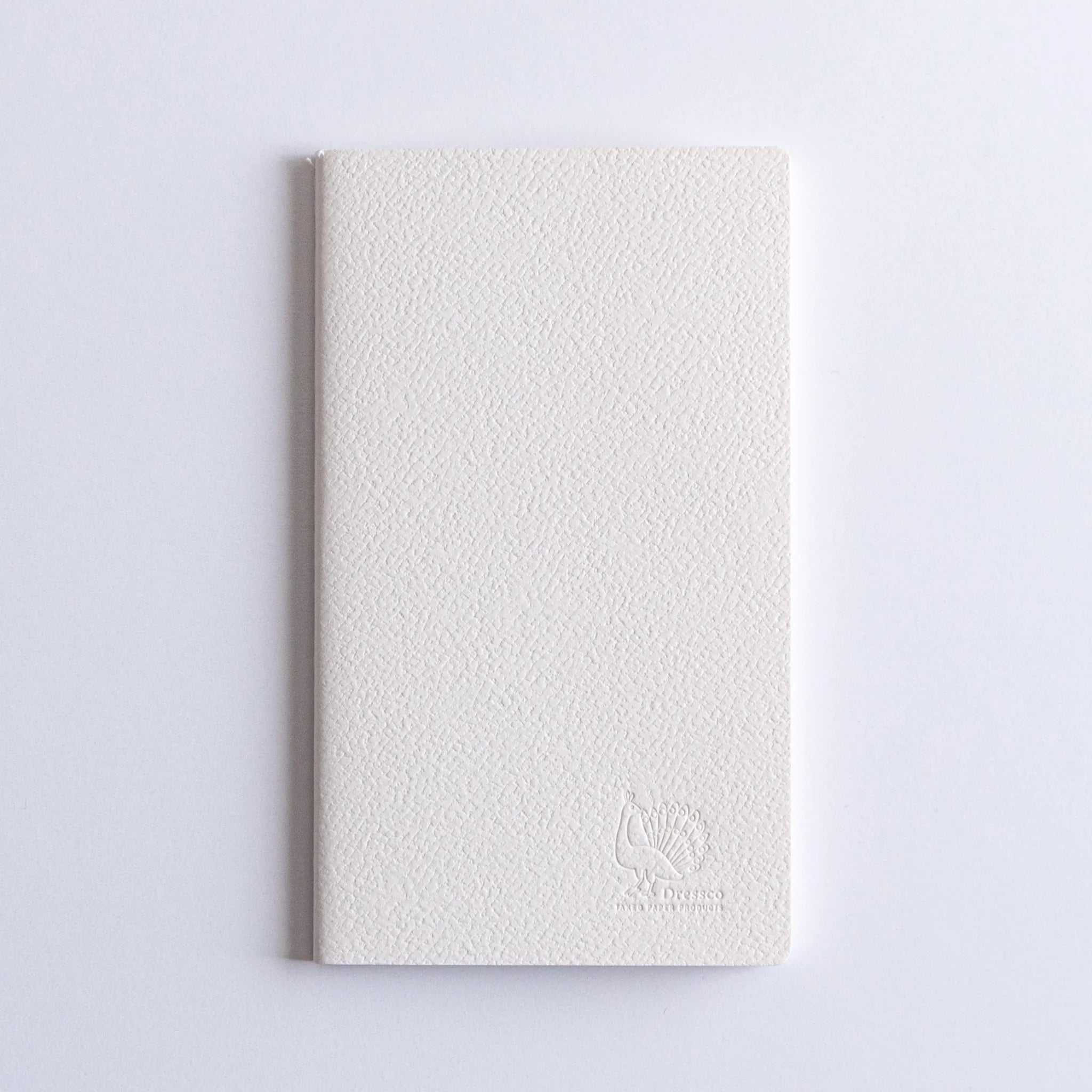 Close-up texture view of Dressco Spica Laid Bond Stitched A6 notebook showing the cover material and laid paper surface