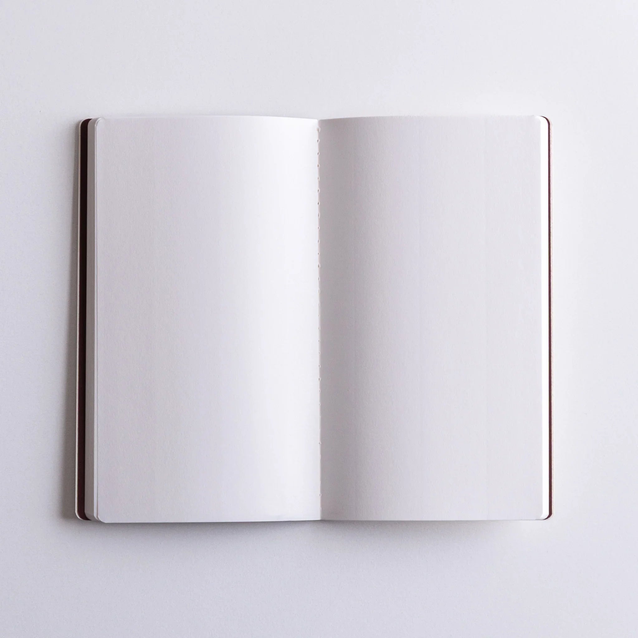 Detailed view of Dressco Spica Laid Bond Stitched A6 notebook surface showing the cover texture and binding quality