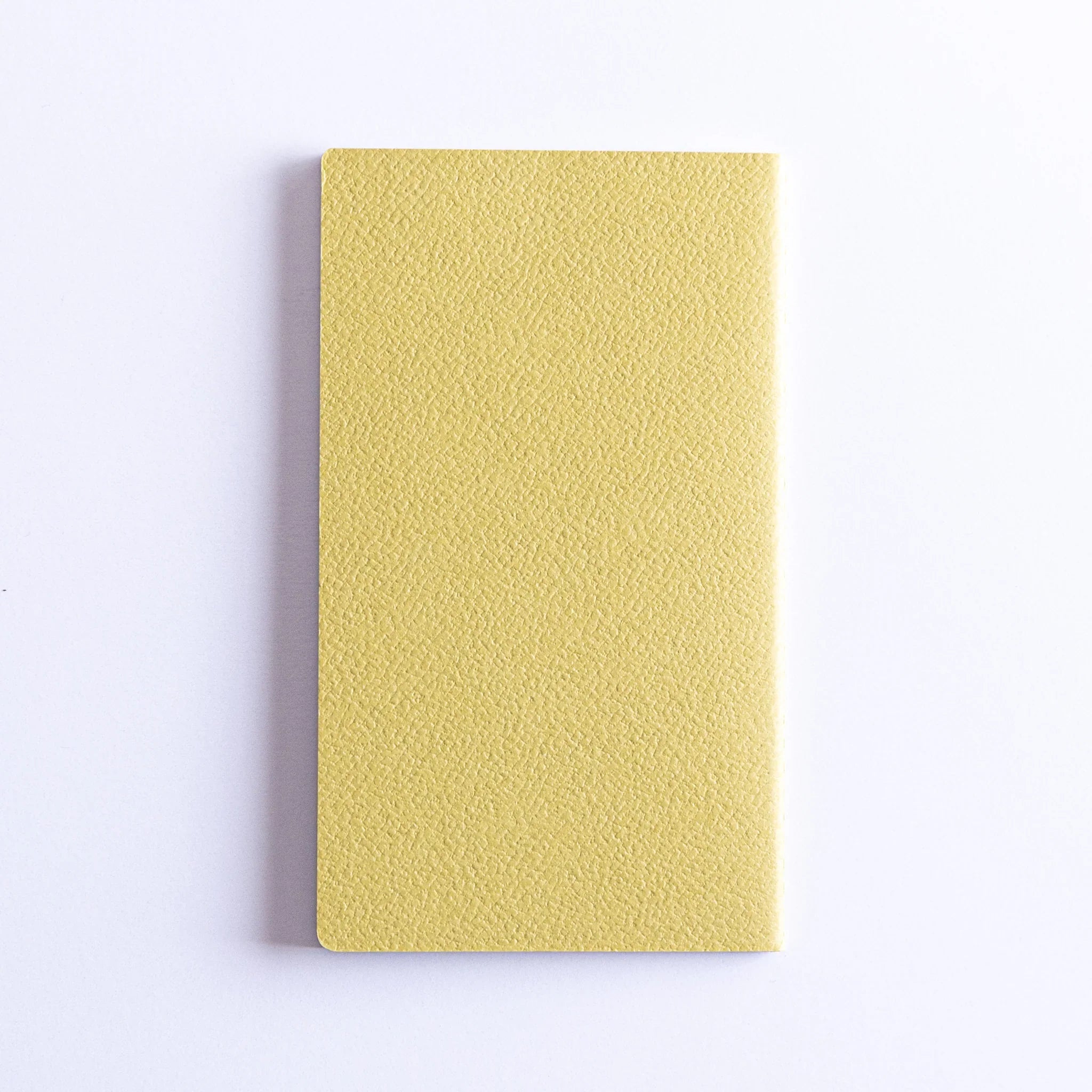 Dressco Spica Laid Bond Stitched A6 notebook standing upright showing front cover and stitched Japanese notebook design