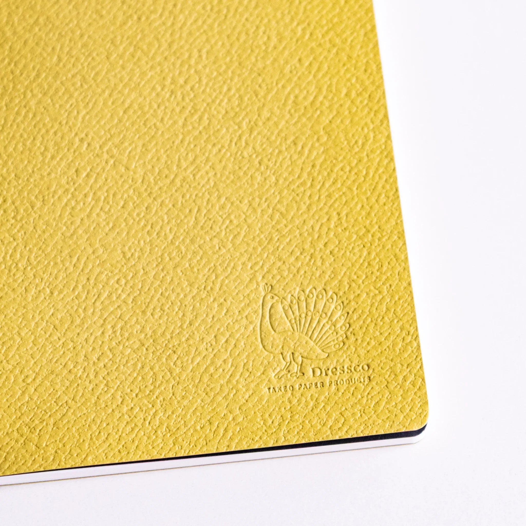 Dressco stitched stationery set four notebooks, angled view of embossed design                                