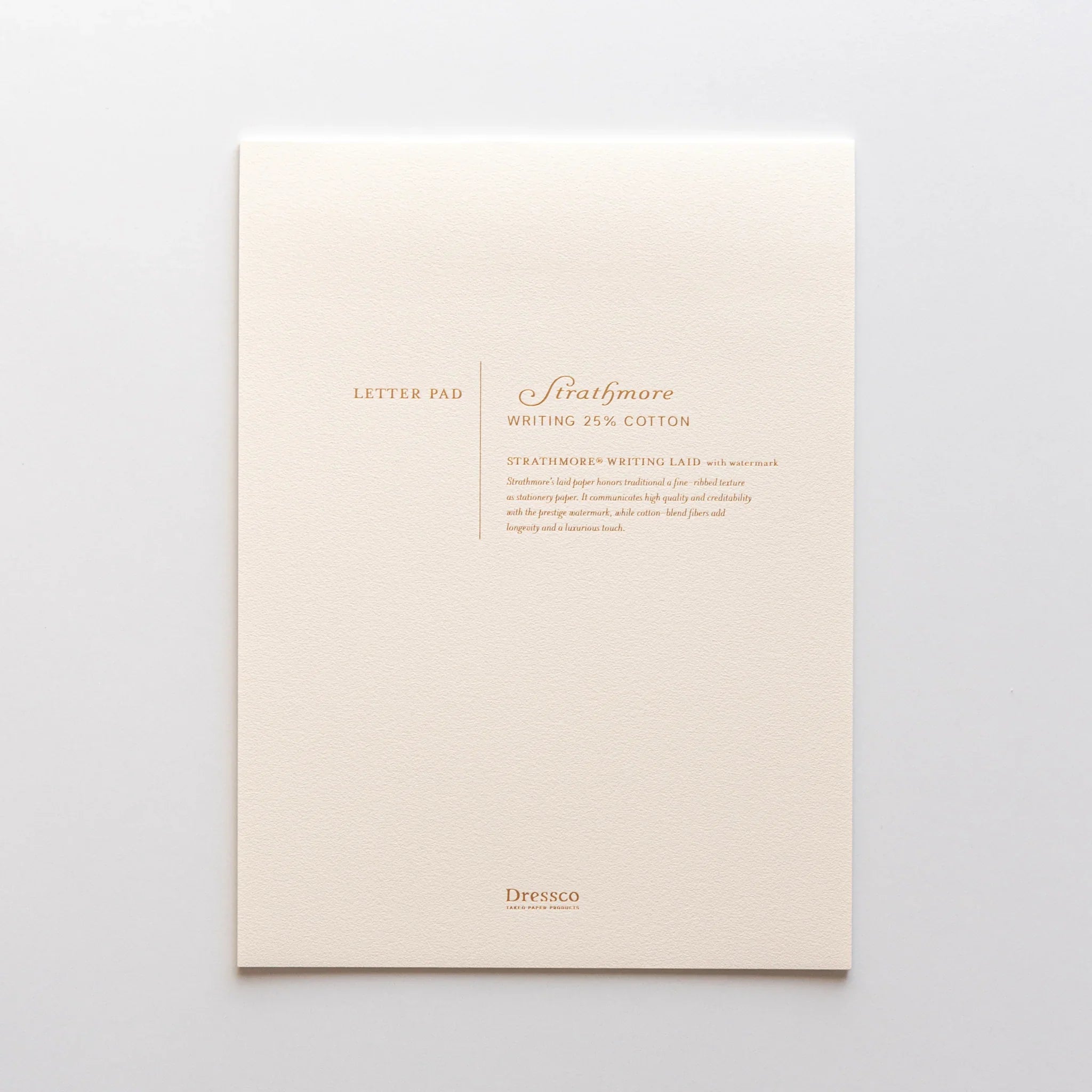 Cream Strathmore writing pad with white Strathmore 25% cotton text print and gold watermark on front cover
