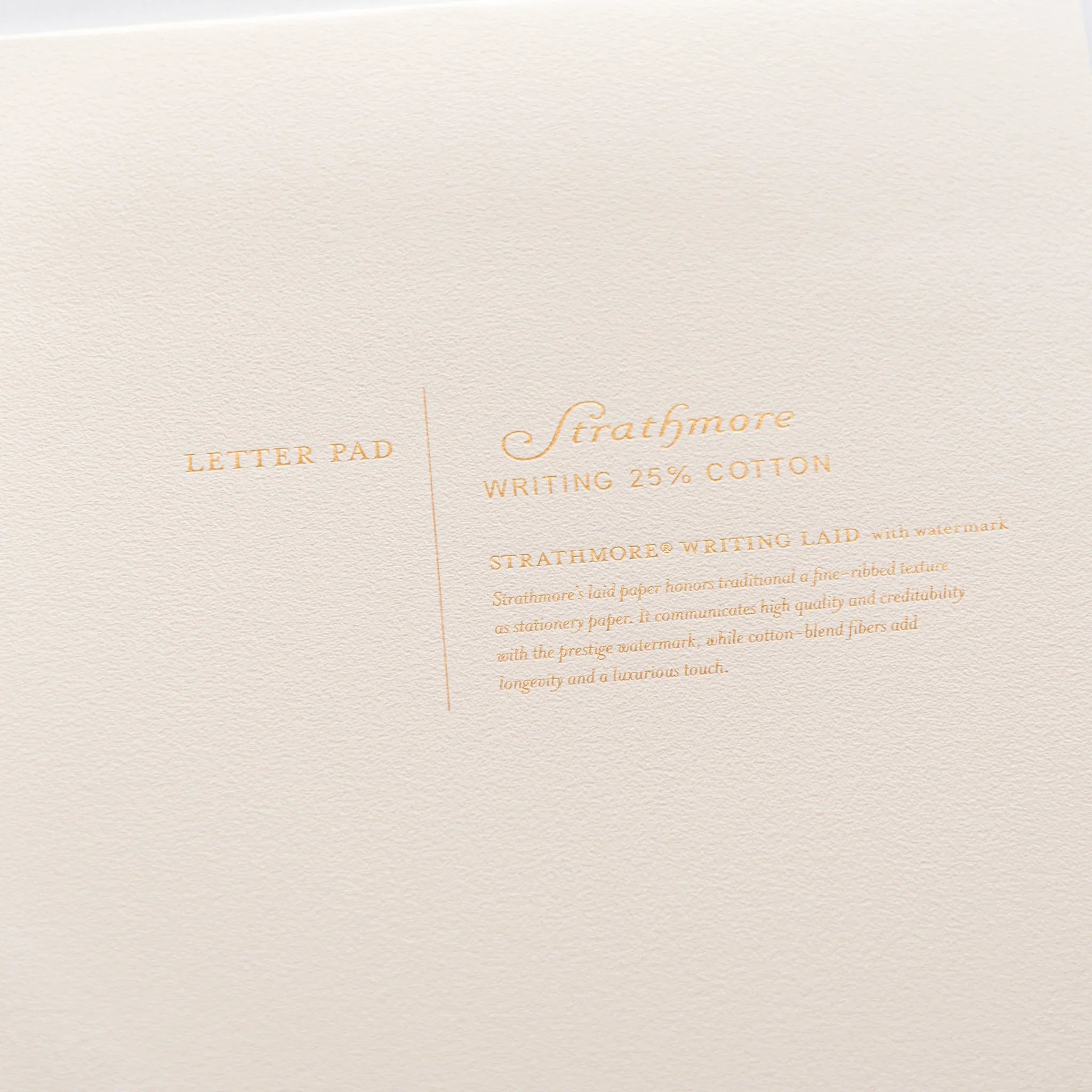 Close-up detail of Dressco branding and logo on cream Strathmore writing pad cover composition shown