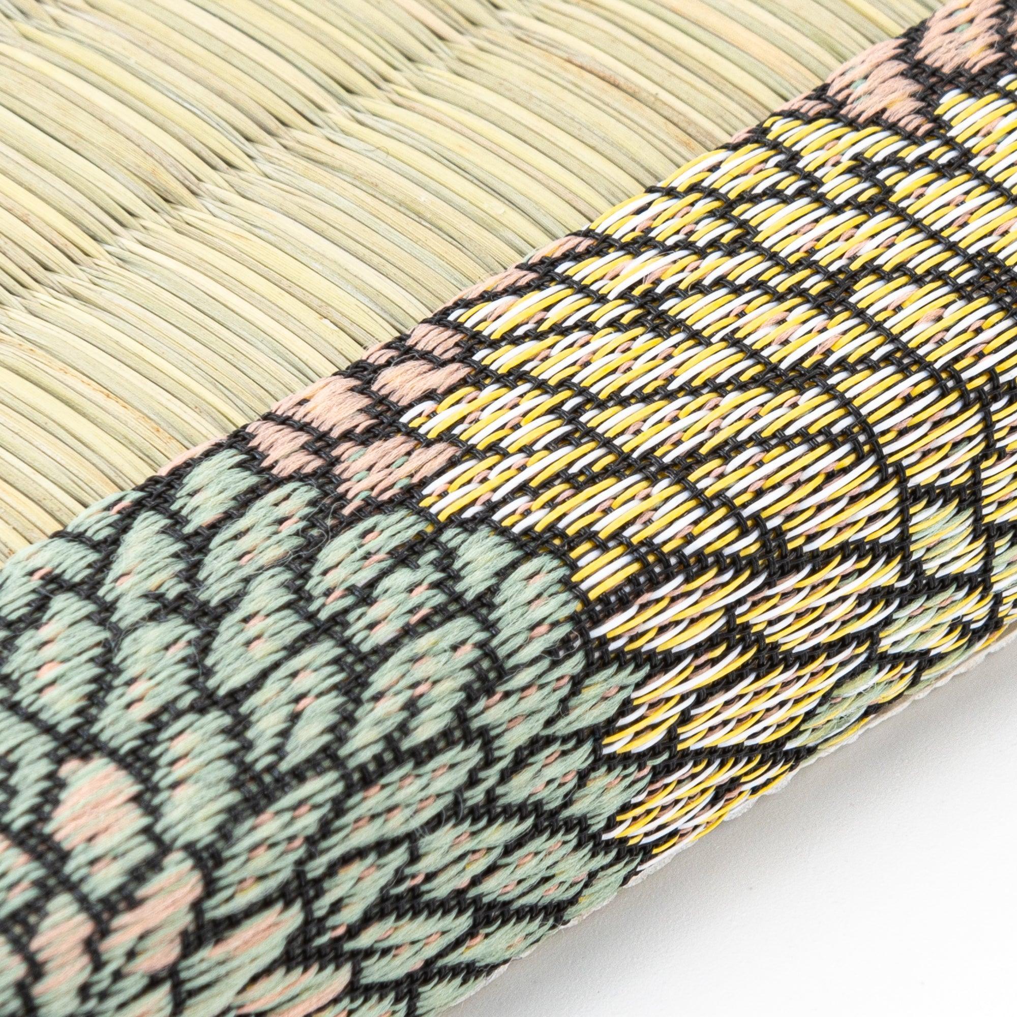 Macro view of Chrysanthemum Tatami Pen Tray edge where rush weave tatami meets the woven brocade fabric border