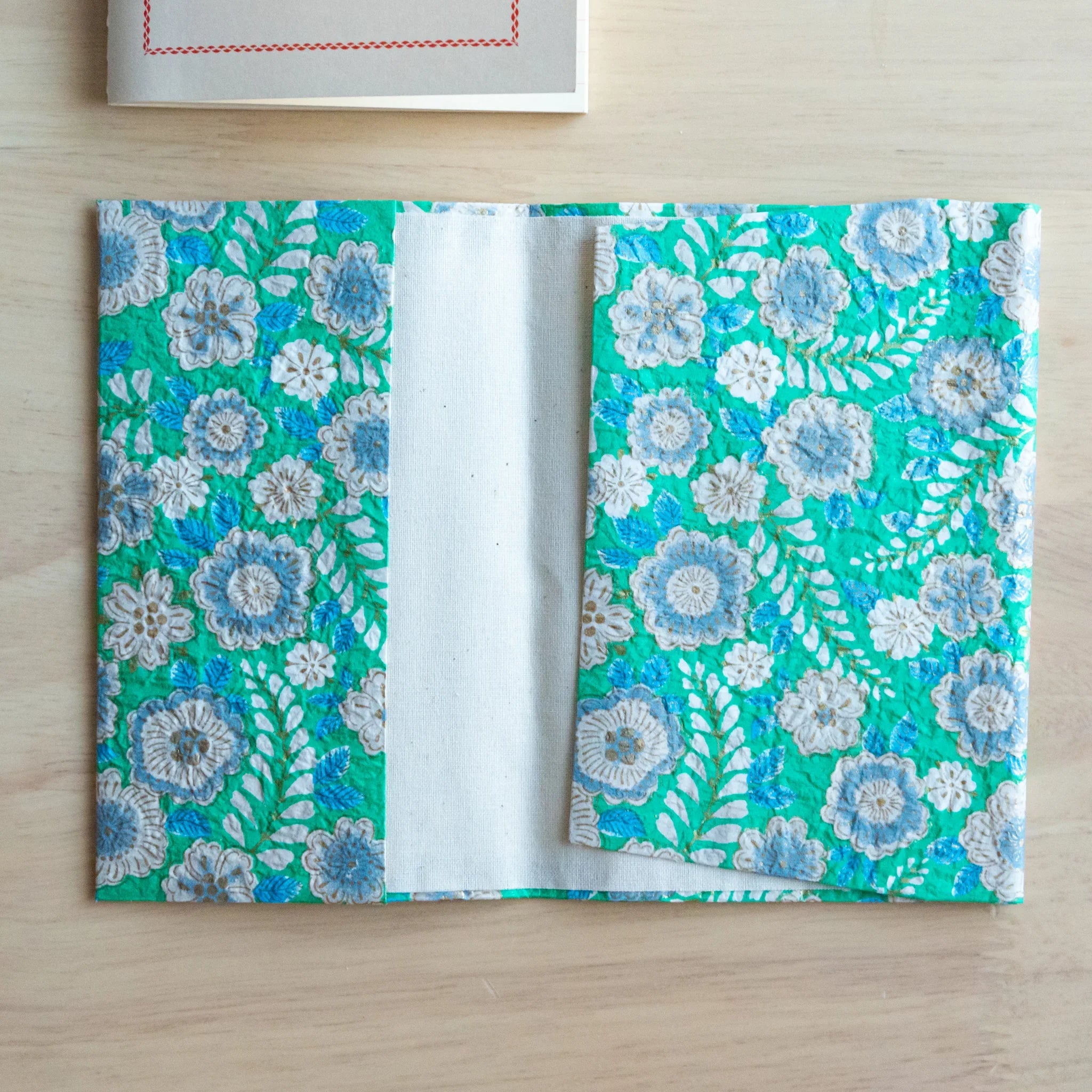 Emerald green hand-dyed yuzen washi book cover A6, close-up of intricate botanical dye pattern and leaf details