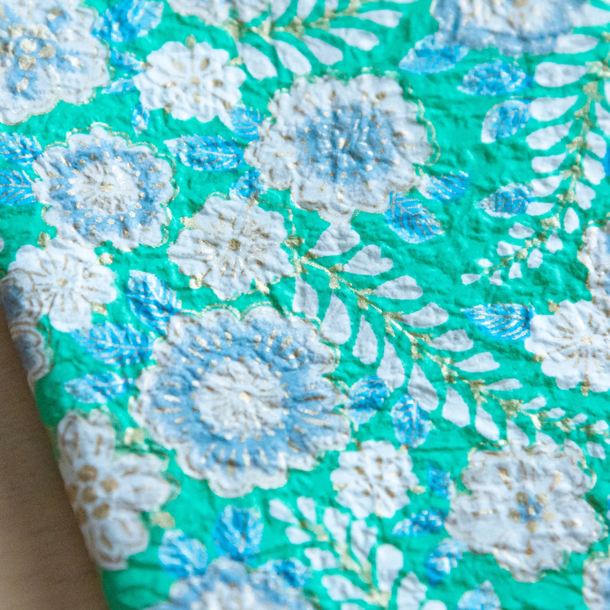 Emerald green hand-dyed yuzen washi book cover A6, side angle view showcasing textured yuzen dye application art