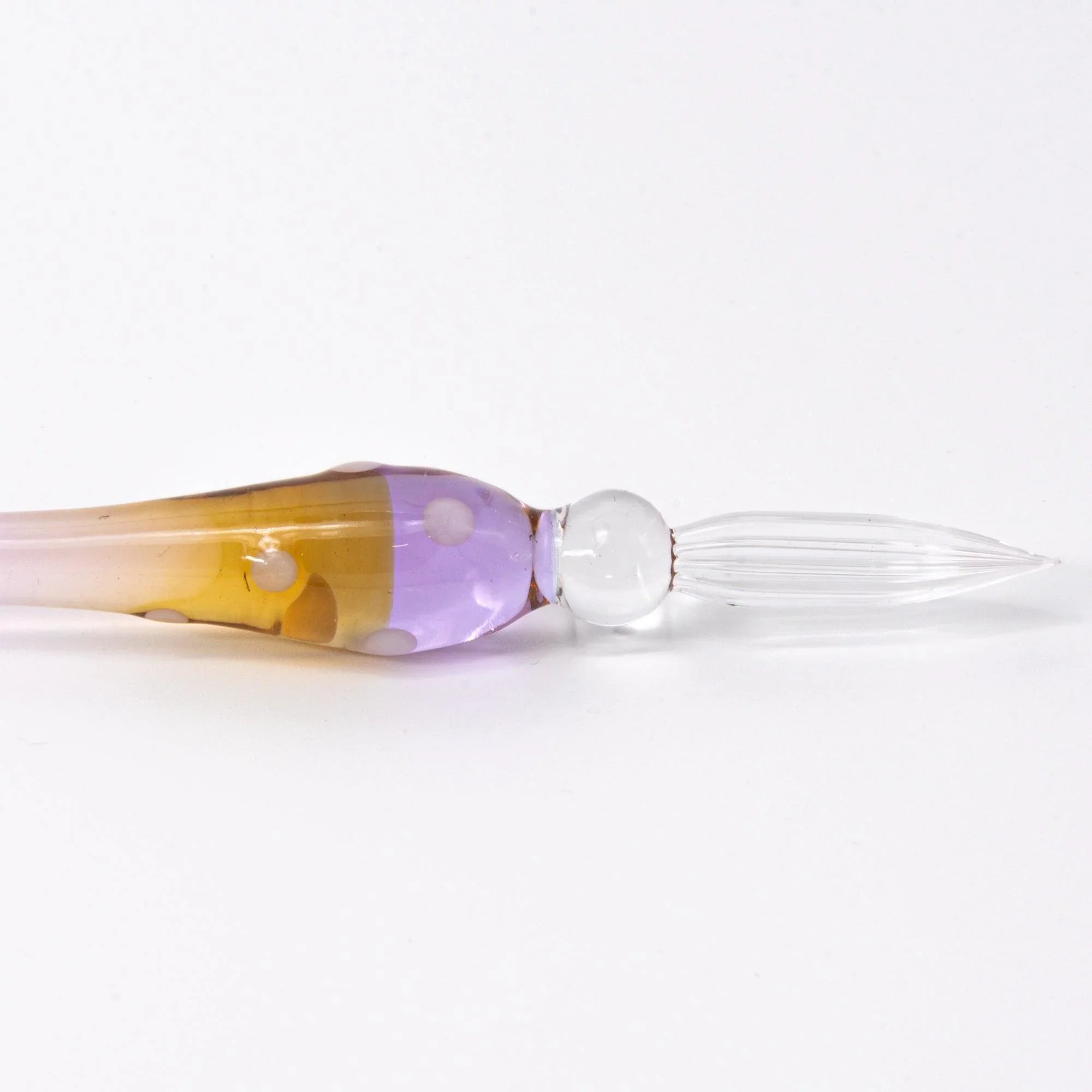 Marun-Chan glass dip pen displayed with brush tip visible, polka-dot glass design on pink background
