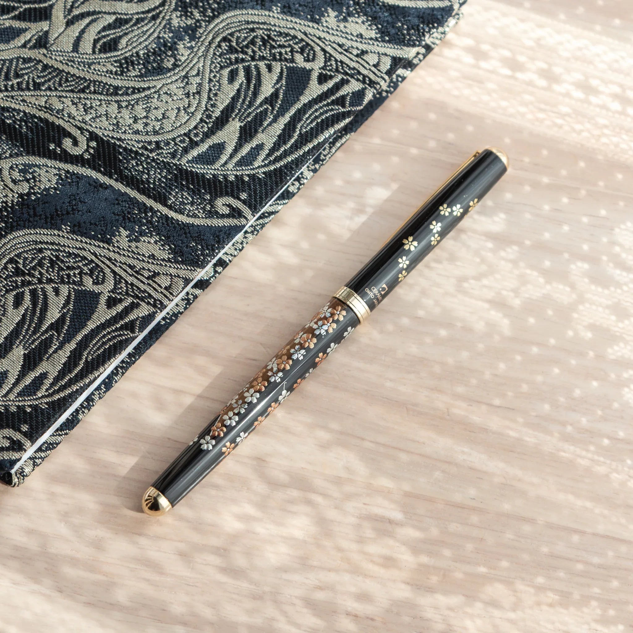 Hand-turned Yamanaka wooden ballpoint pen features red and gold fuji sakura landscape lacquer painting