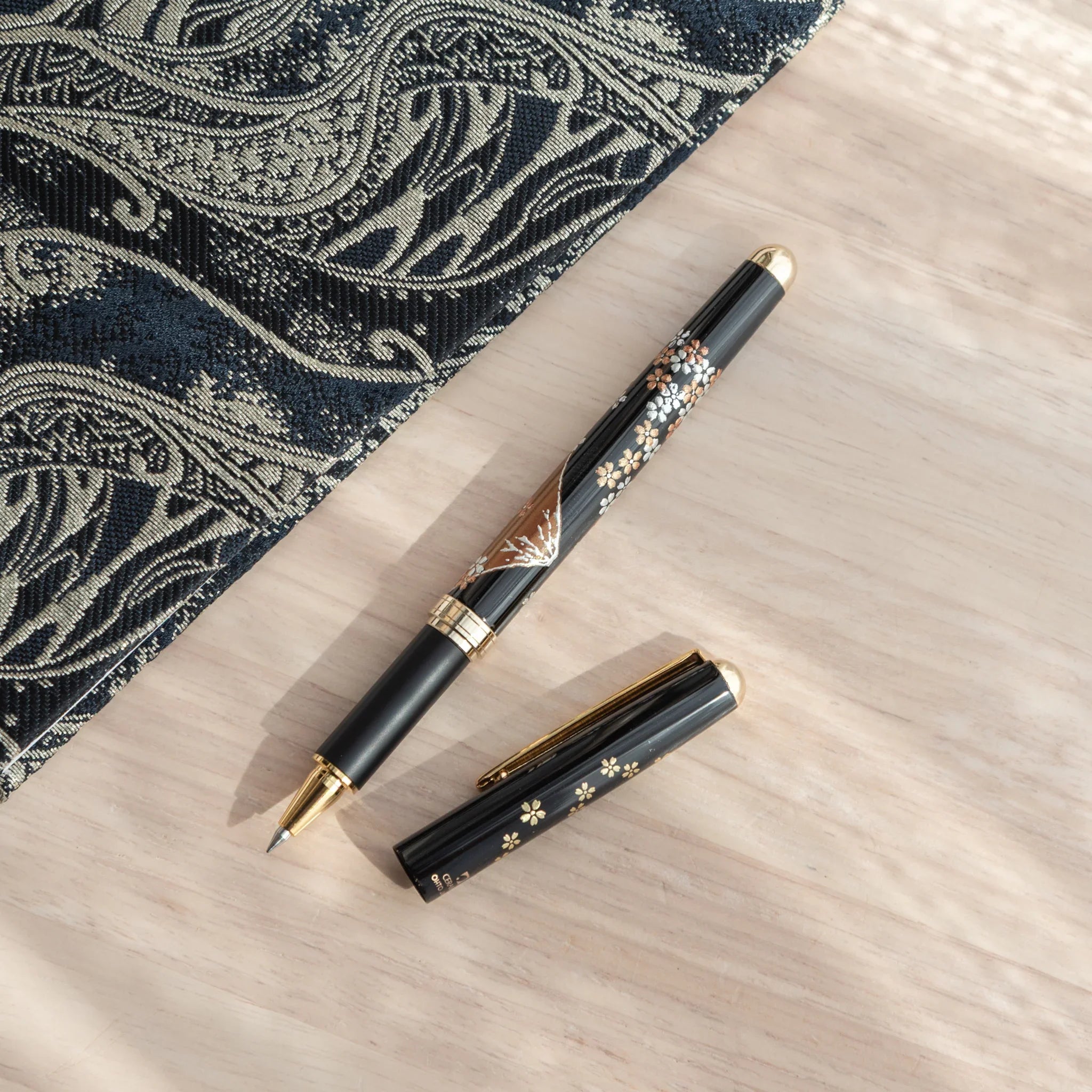 Traditional Yamanaka lacquered ballpoint pen depicts Mount Fuji with pink spring sakura blossom detail