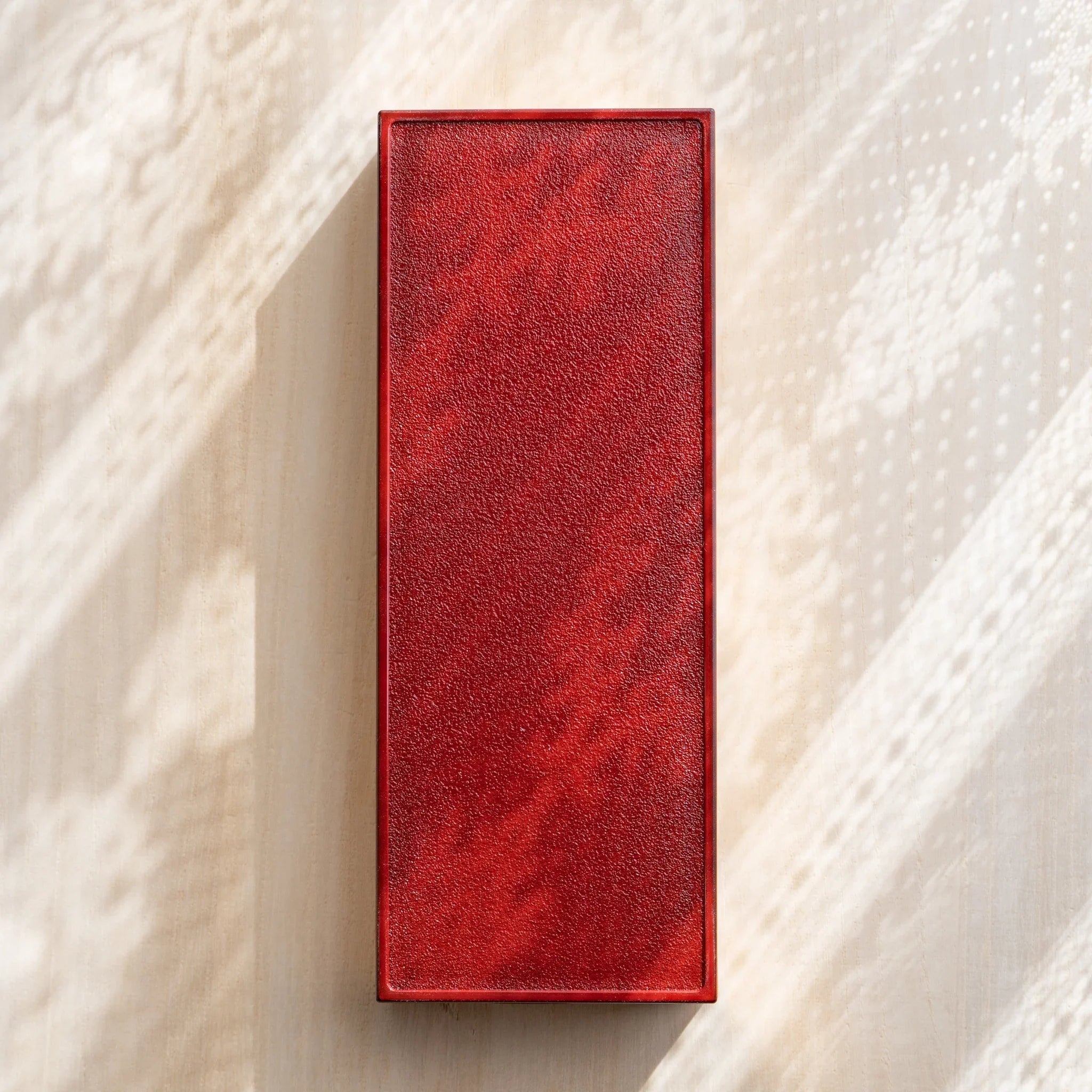 Decorated gold case showing full Mt. Fuji composition with scattered sakura flower motifs shown in composition