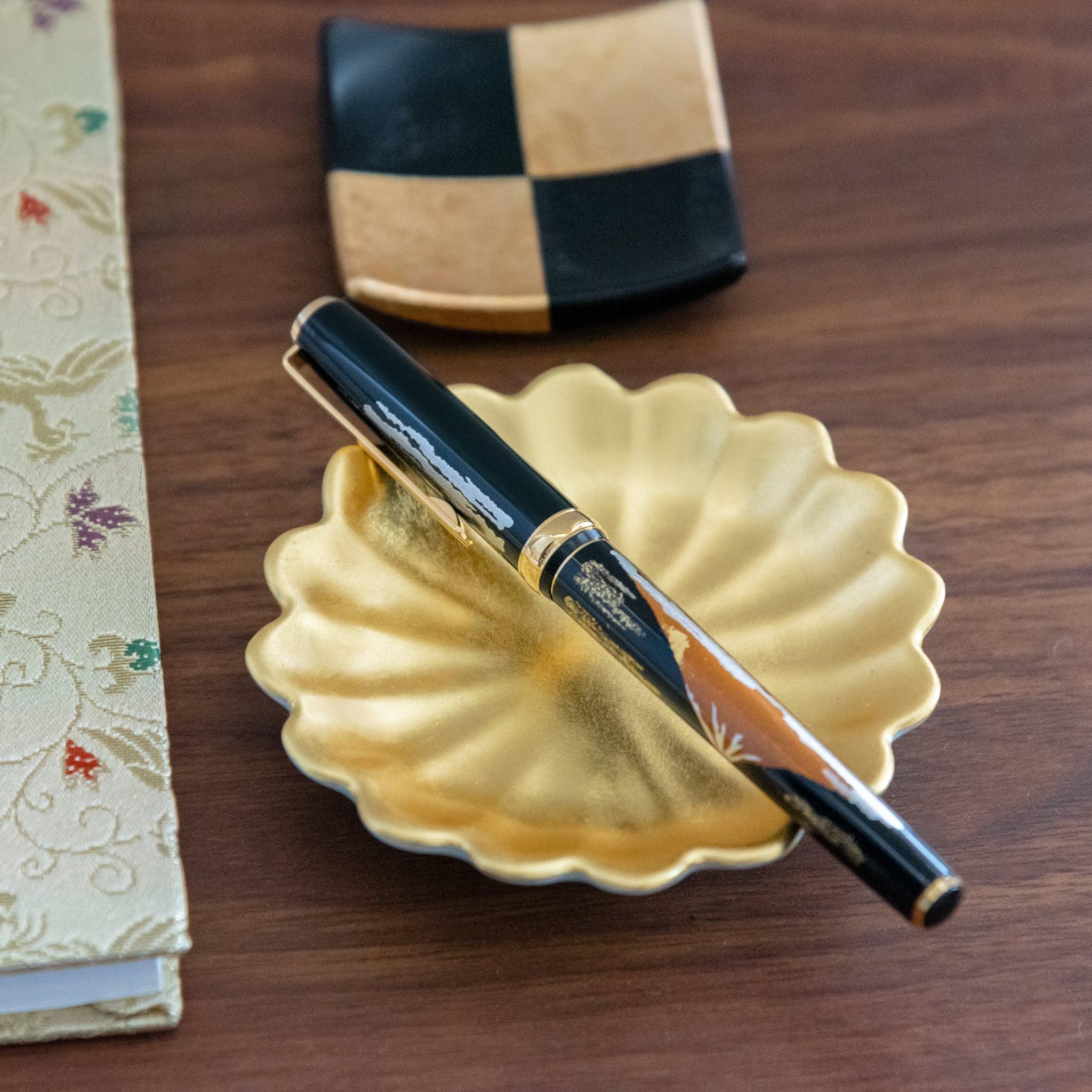 Gold leaf chrysanthemum pen holder detail showing golden chrysanthemum flowers, traditional Japanese artisanal lacquerware