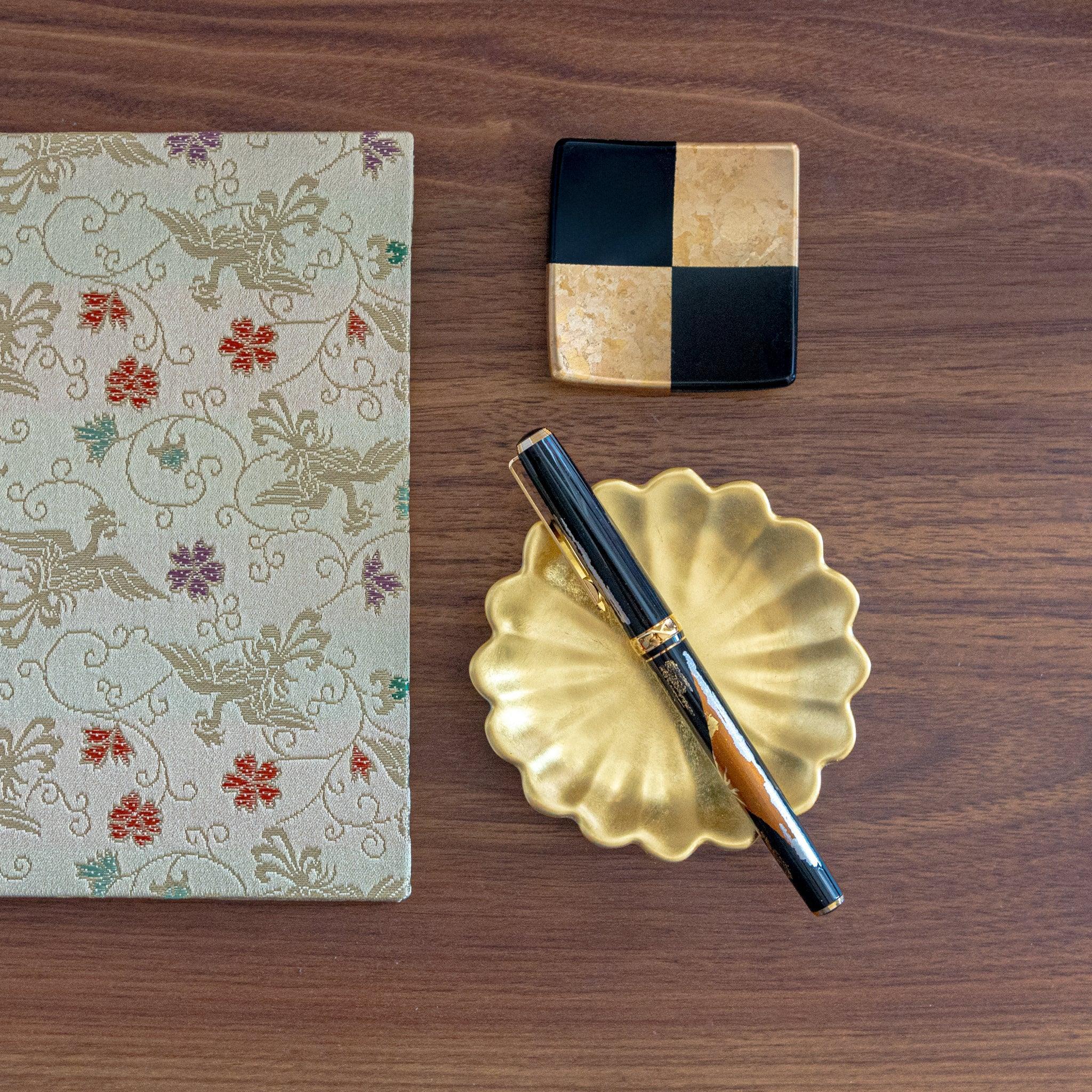 Gold leaf chrysanthemum pen holder angled view with kiku pattern and metallic gold leaf details, traditional lacquer