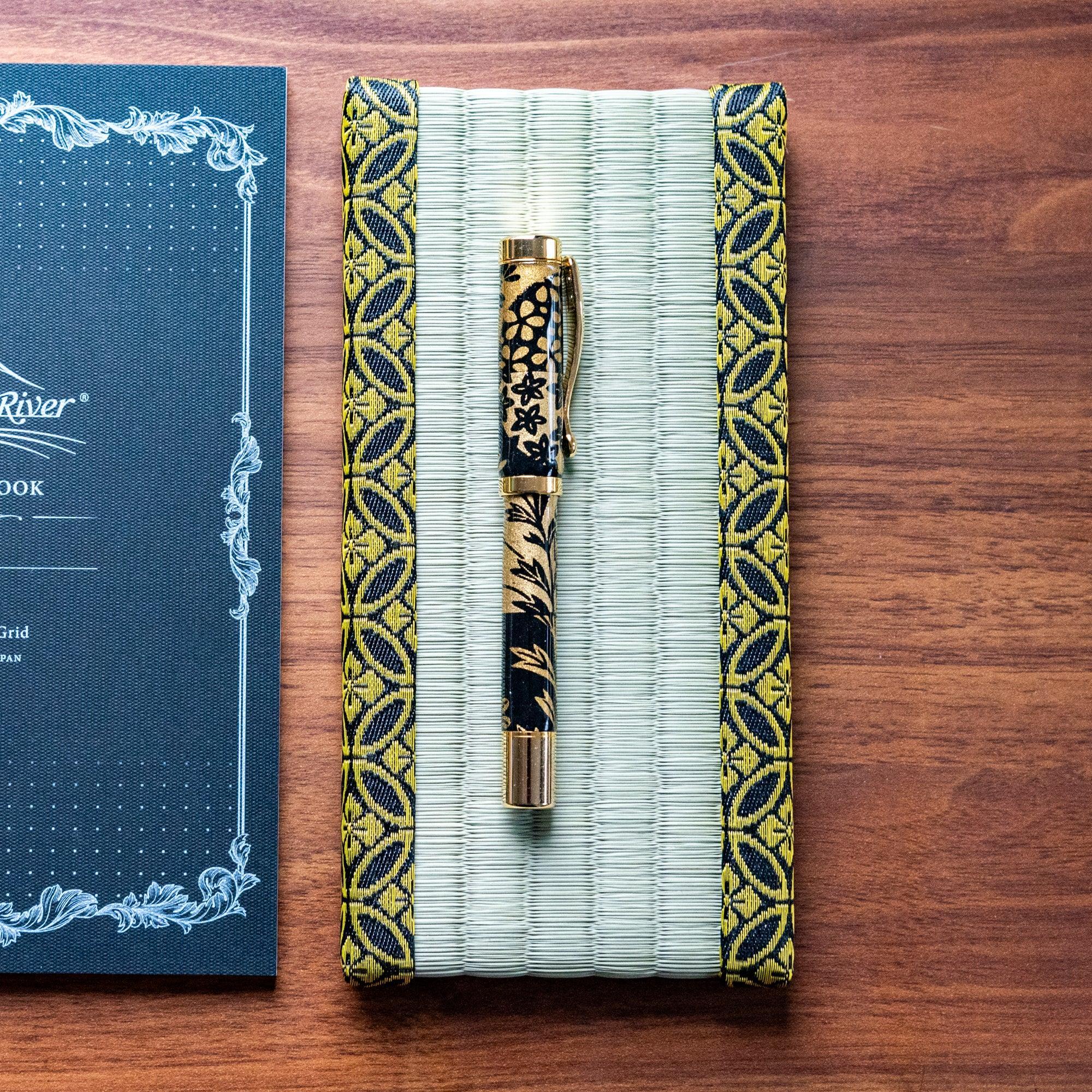 Woven straw tatami pen tray with gold shippo geometric pattern border trim detail clearly visible on display