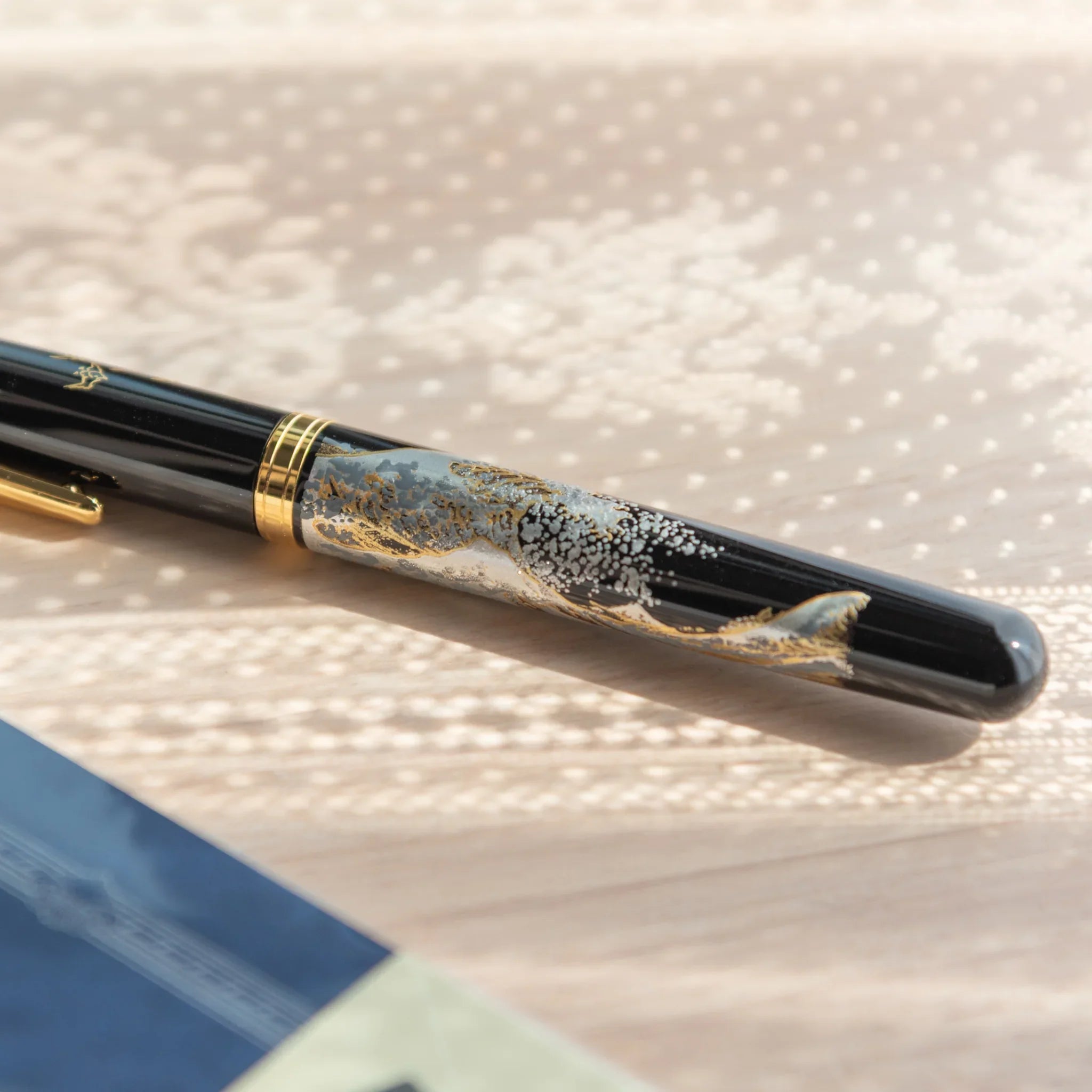 Hand-turned Yamanaka wooden fountain pen features blue seascape and ukiyo-e wave artwork design for writing