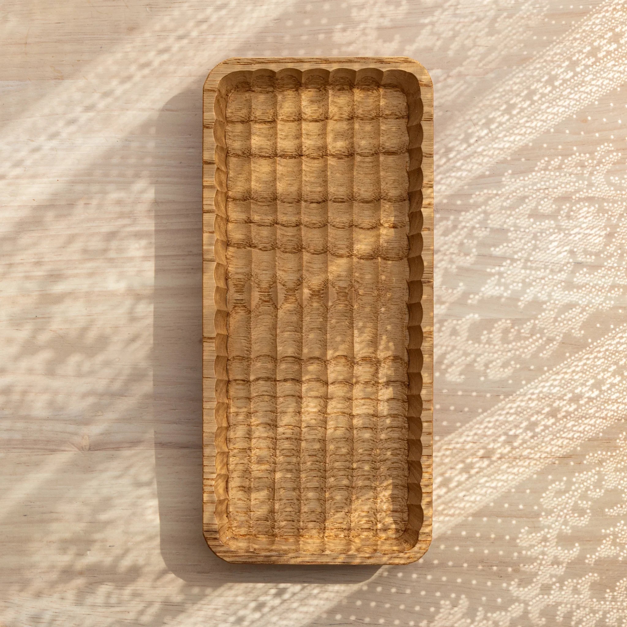 Hand-carved wooden tray detail showing carved ridge texture and pattern clearly visible with precise carving detail