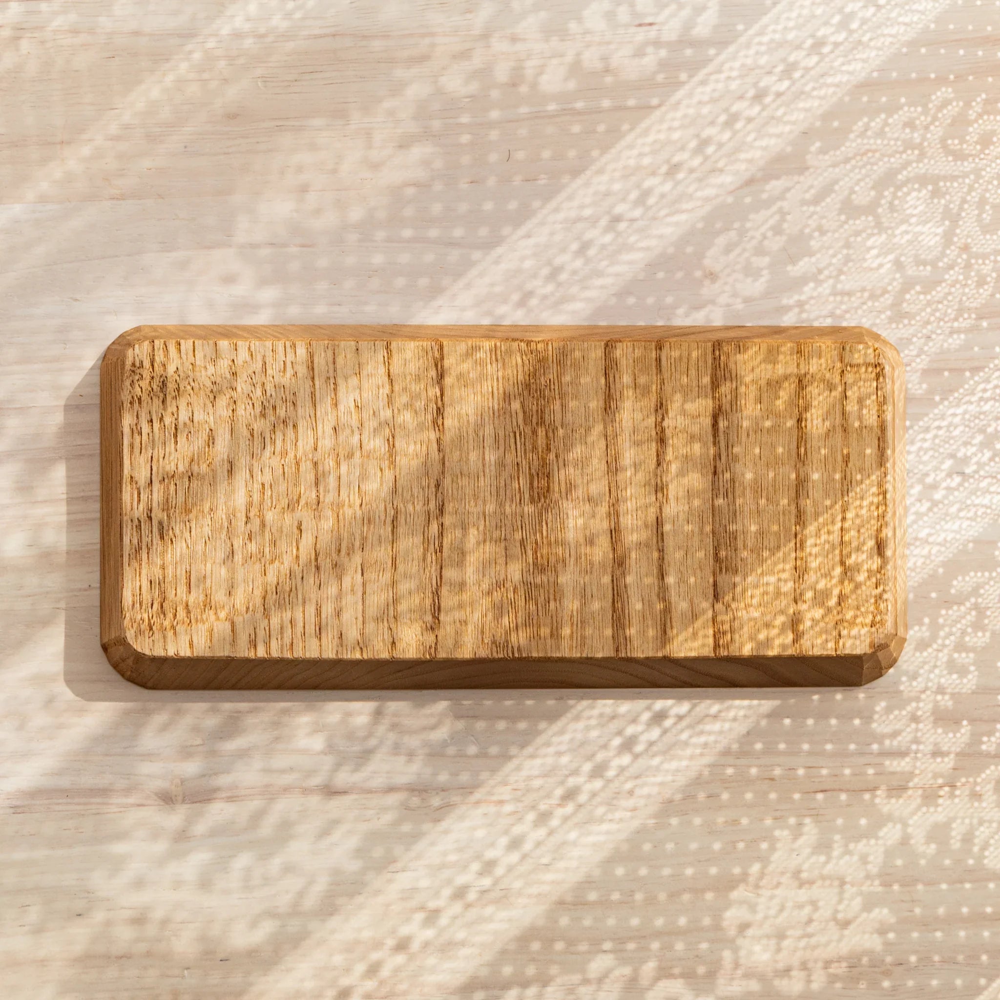 Hand-carved Wagatabon tray with decorative pens displayed in grooves displayed clearly with precise carving detail