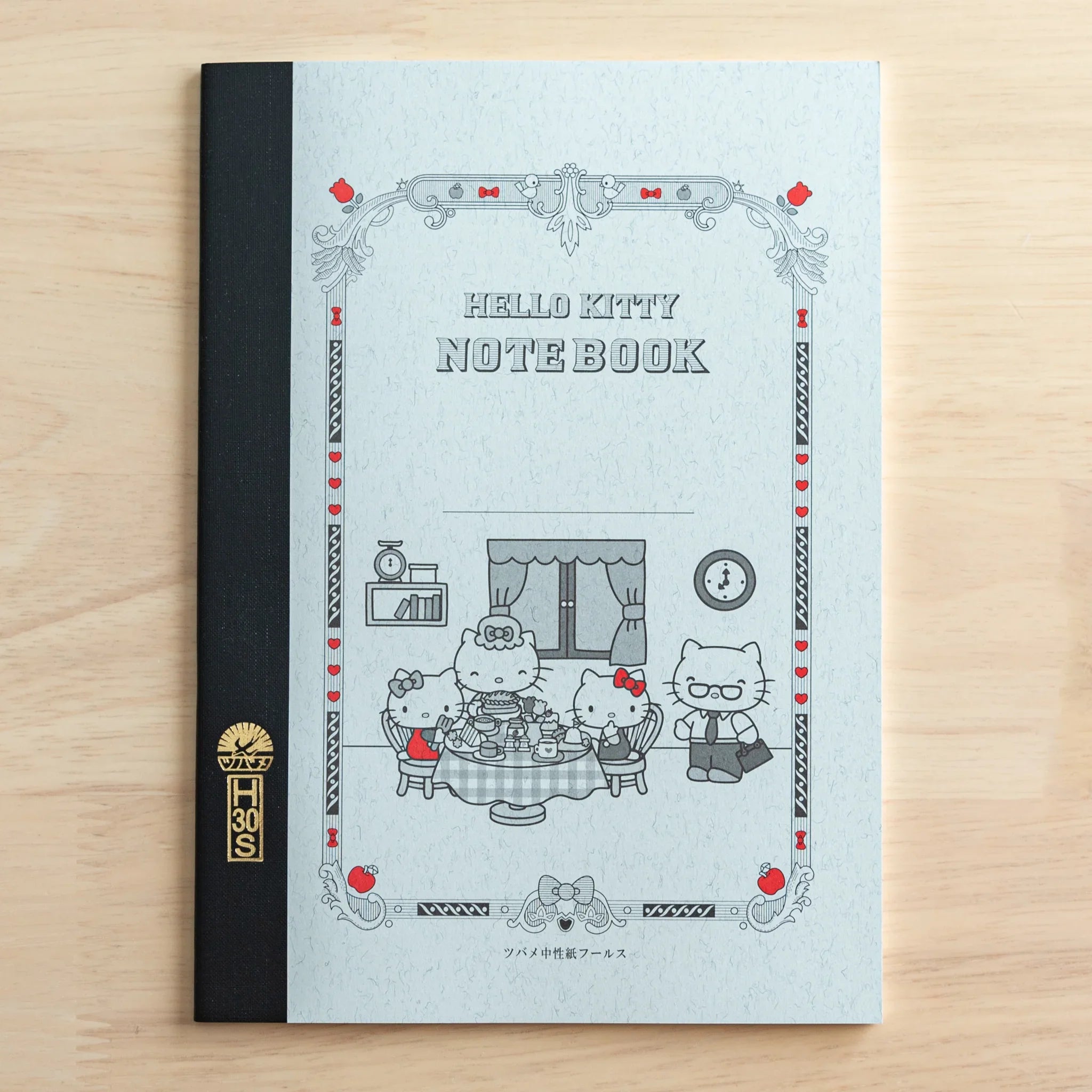 Hello Kitty Tsubame notebook front cover with light blue background and decorative borders with A5 grid page format and