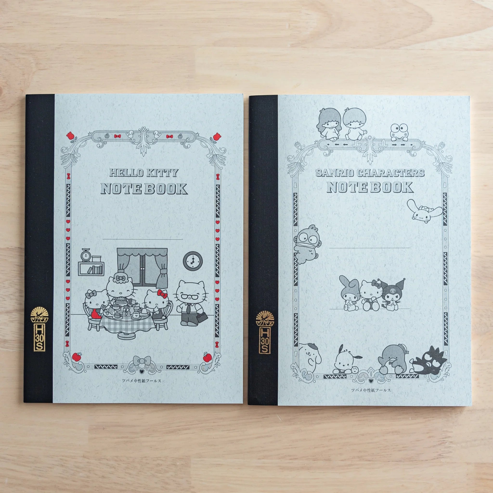 Hello Kitty Tsubame notebook front cover with Hello Kitty seated at table illustration on white background detail view