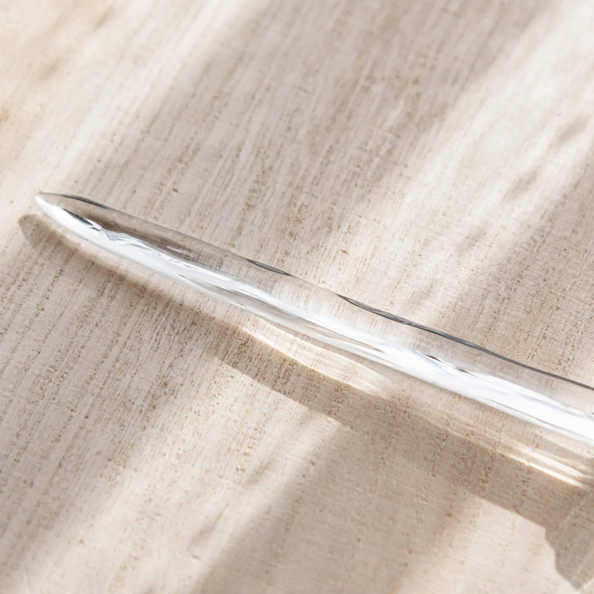Hikari glass letter opener with clear glass shown in composition detail shown in detail product composition view