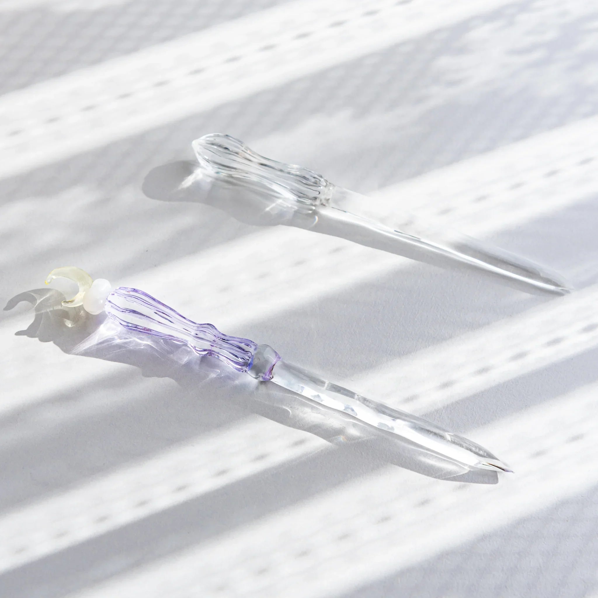 Moonlit cloud glass letter opener with lavender tint shown in composition in detail view composition