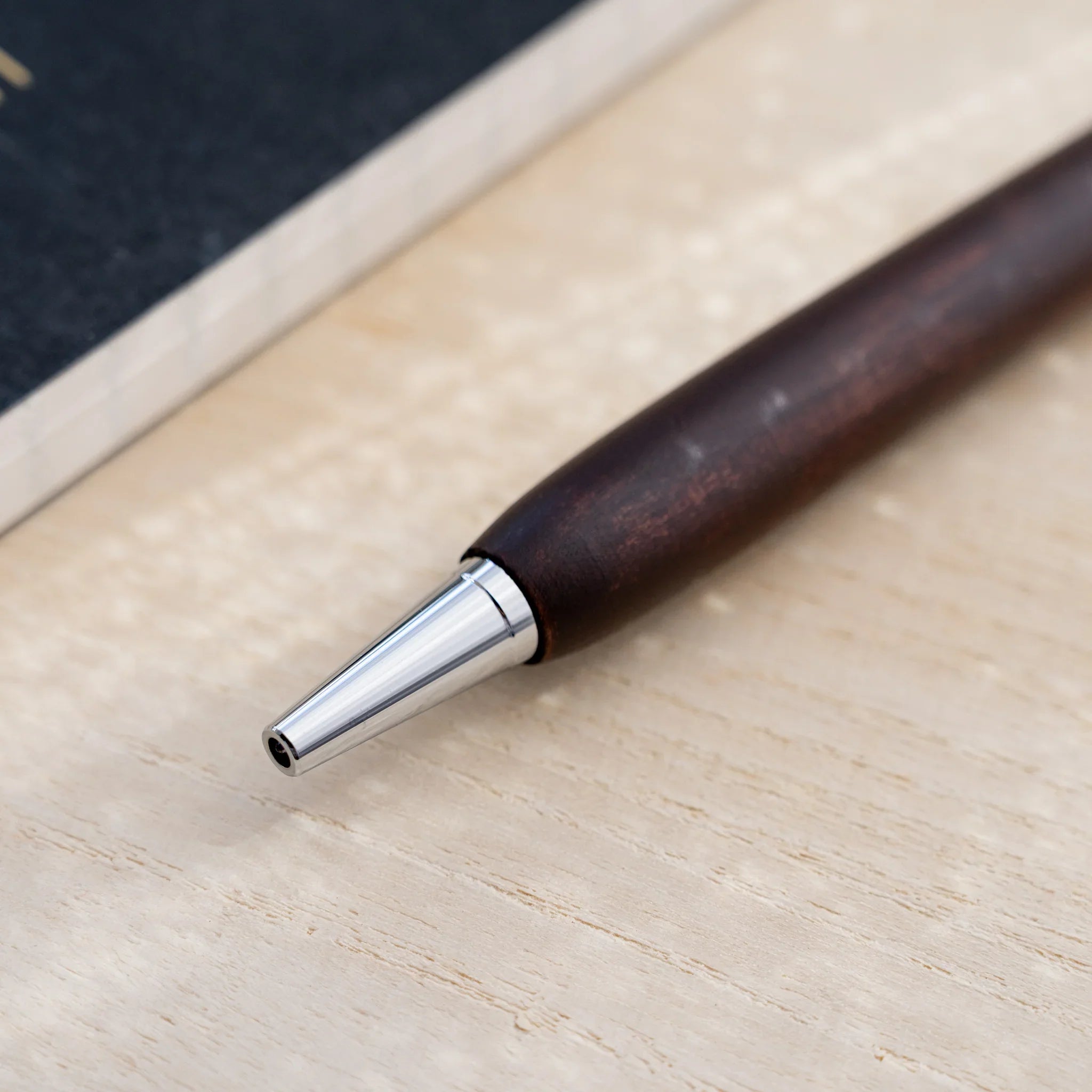 Chocolate brown horse chestnut wood urushi ballpoint pen, close-up of barrel wood grain, Japanese wood