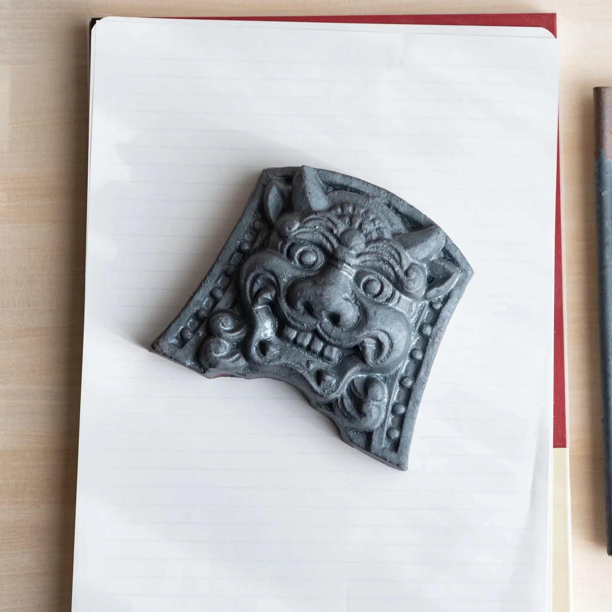 Japanese Kawara large roof guardian ceramic paperweight with resolute expression shown shown composition
