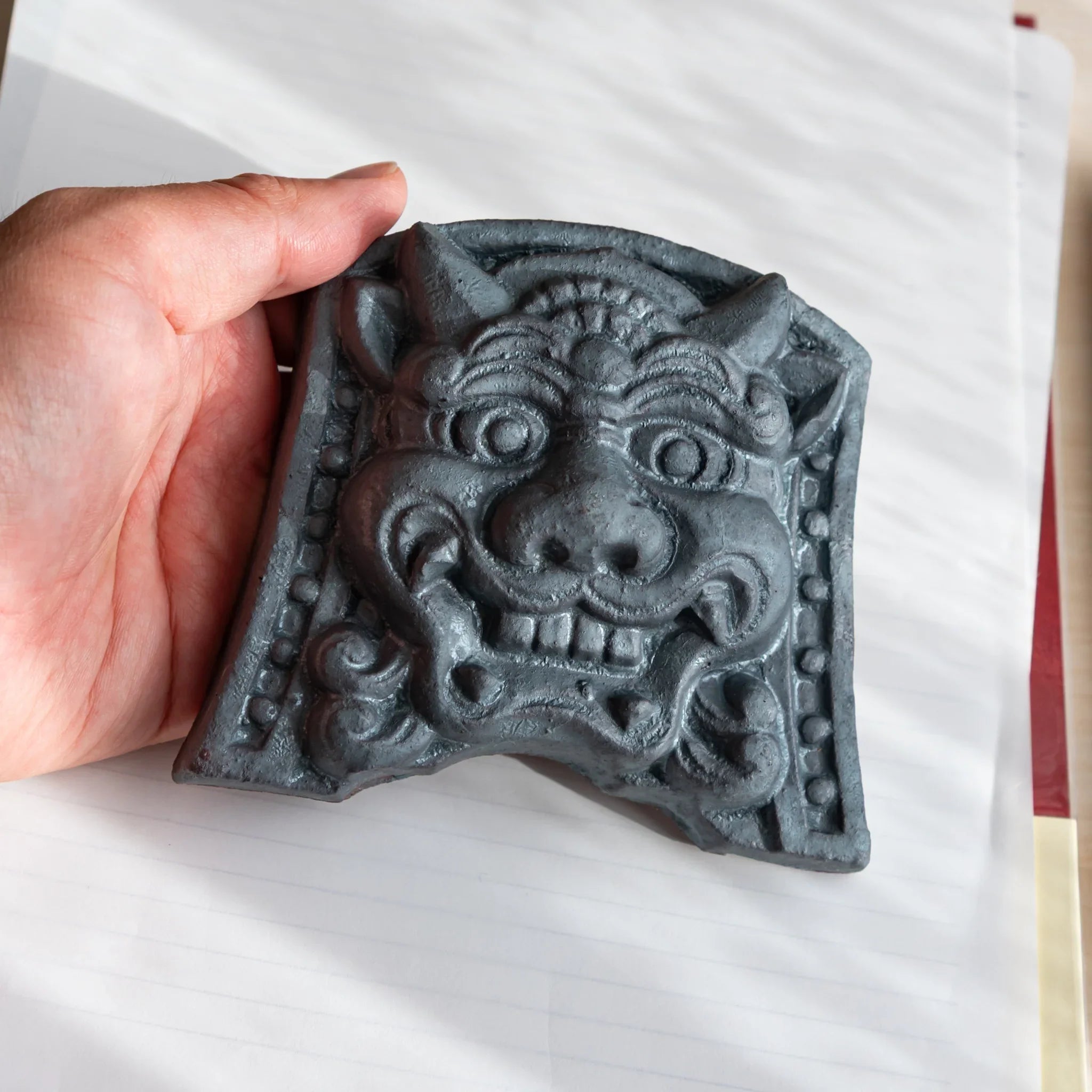 Japanese Kawara large roof guardian ceramic paperweight with resolute expression shown shown view composition