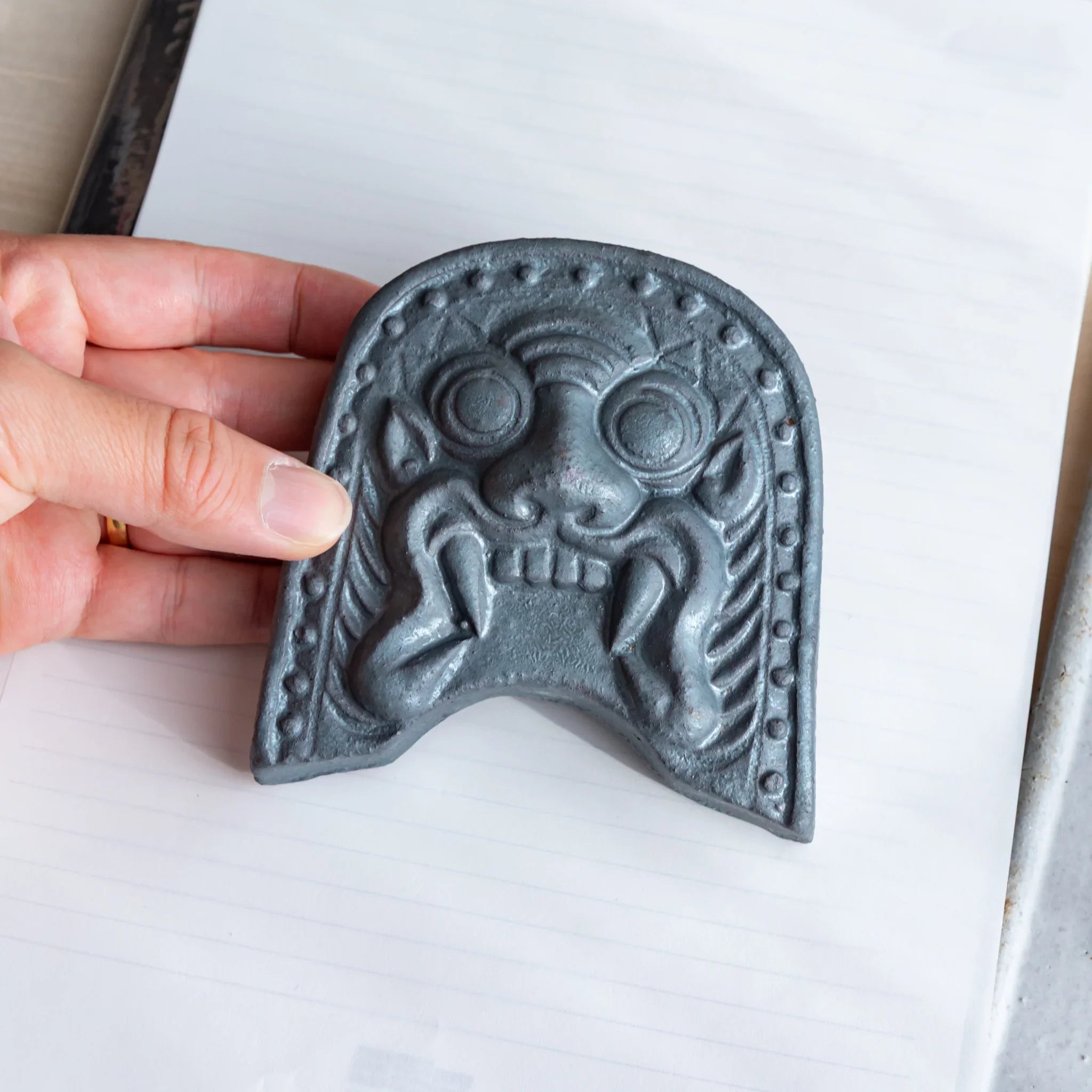 Japanese Kawara large roof guardian ceramic paperweight with steadfast expression shown shown in detail view