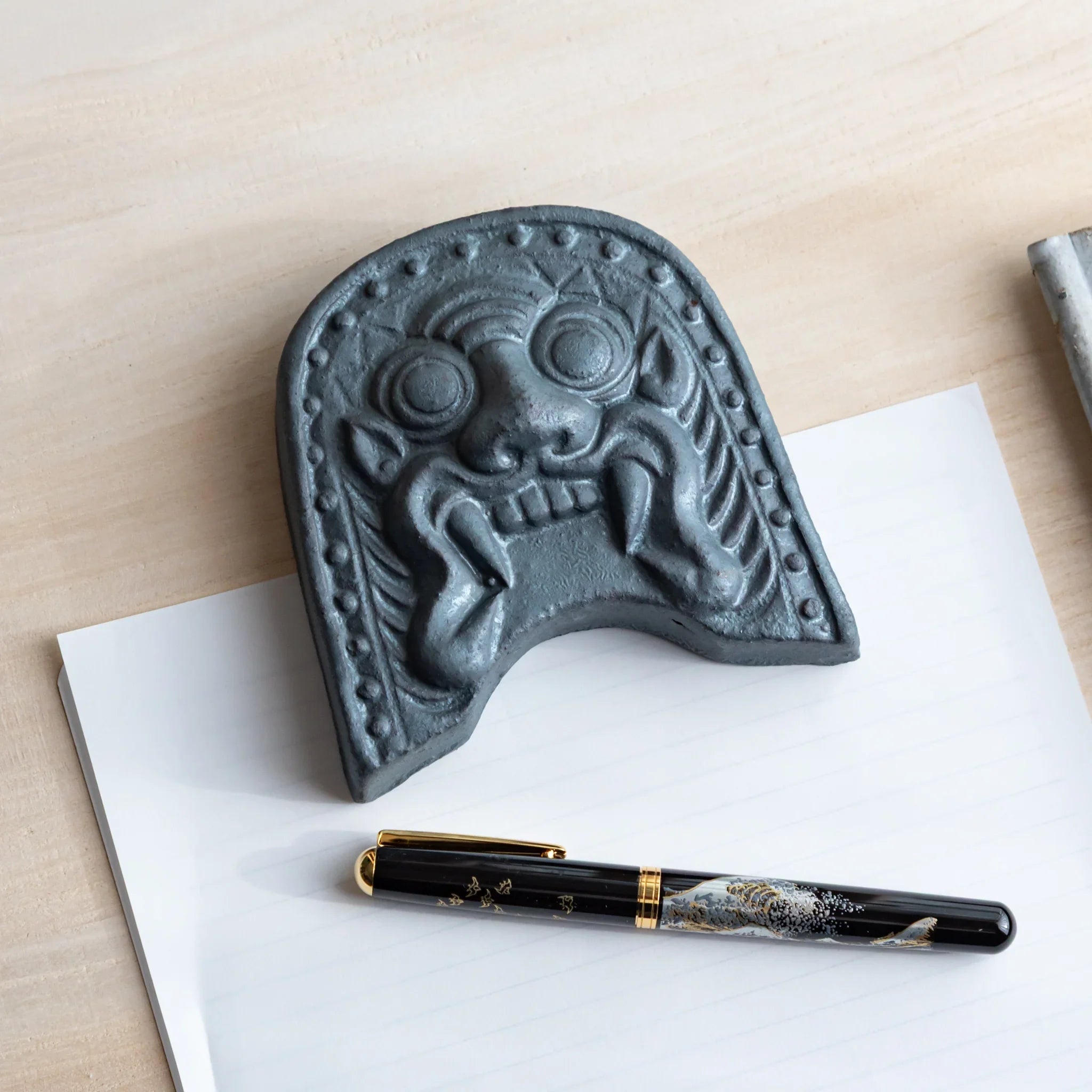 Japanese Kawara large roof guardian ceramic paperweight with steadfast expression shown displayed in detail