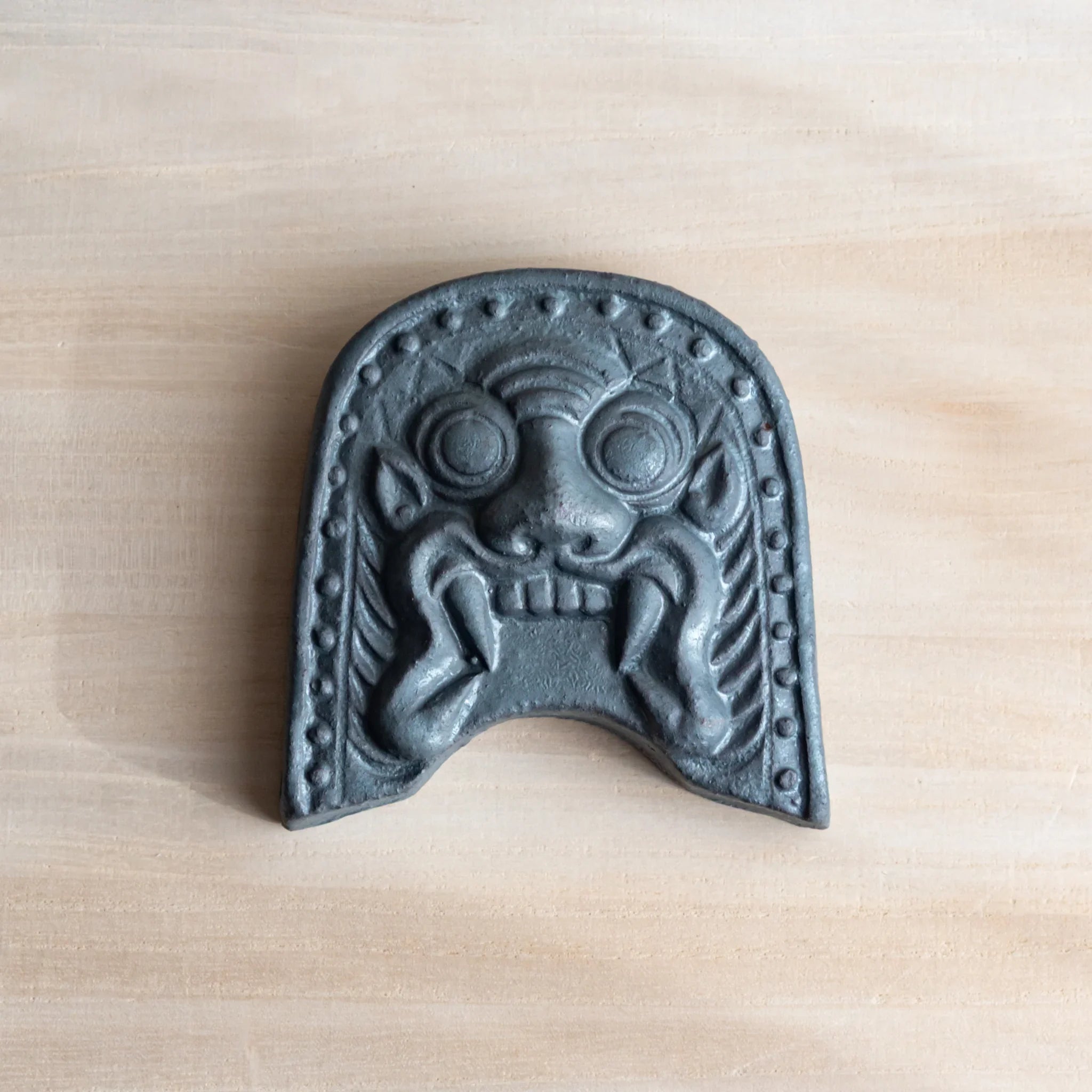 Japanese Kawara large roof guardian ceramic paperweight with steadfast expression shown in detail view composition
