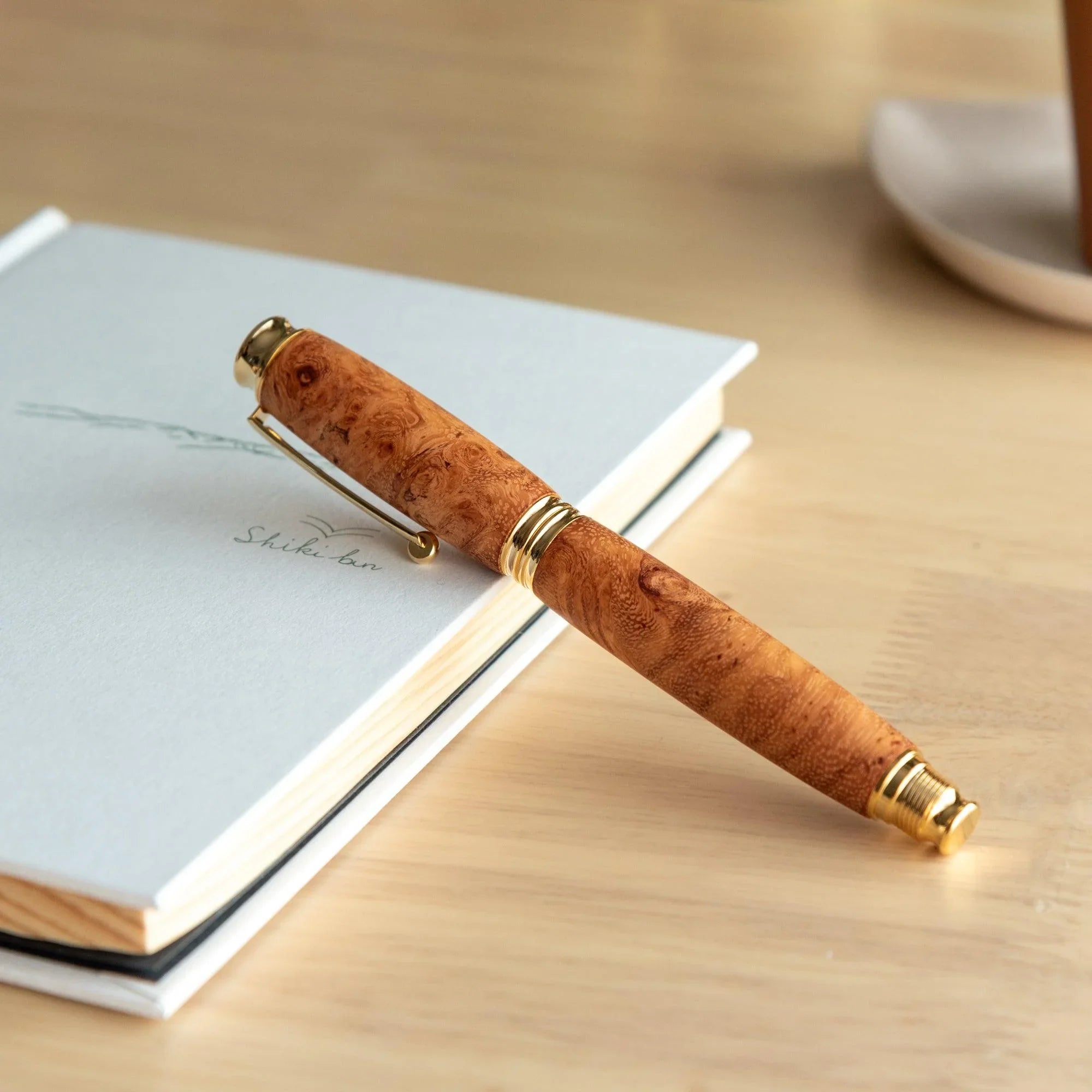 Japanese Karin Wood Screw Cap Fountain Pen with natural wood barrel and gold-tone metal trim accents overall