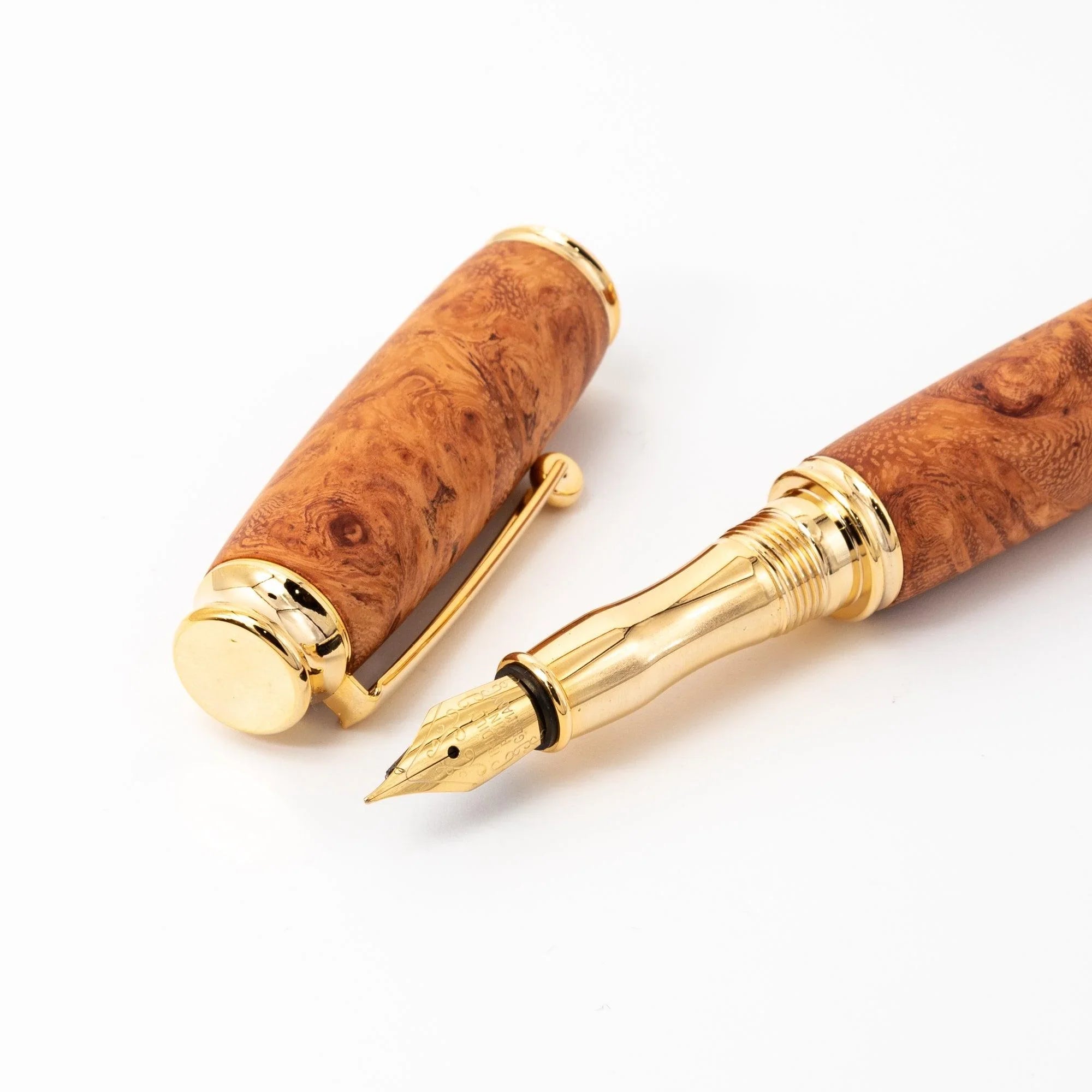 Japanese Karin Wood Screw Cap Fountain Pen lifestyle shot showing pen being held in human hand on surface