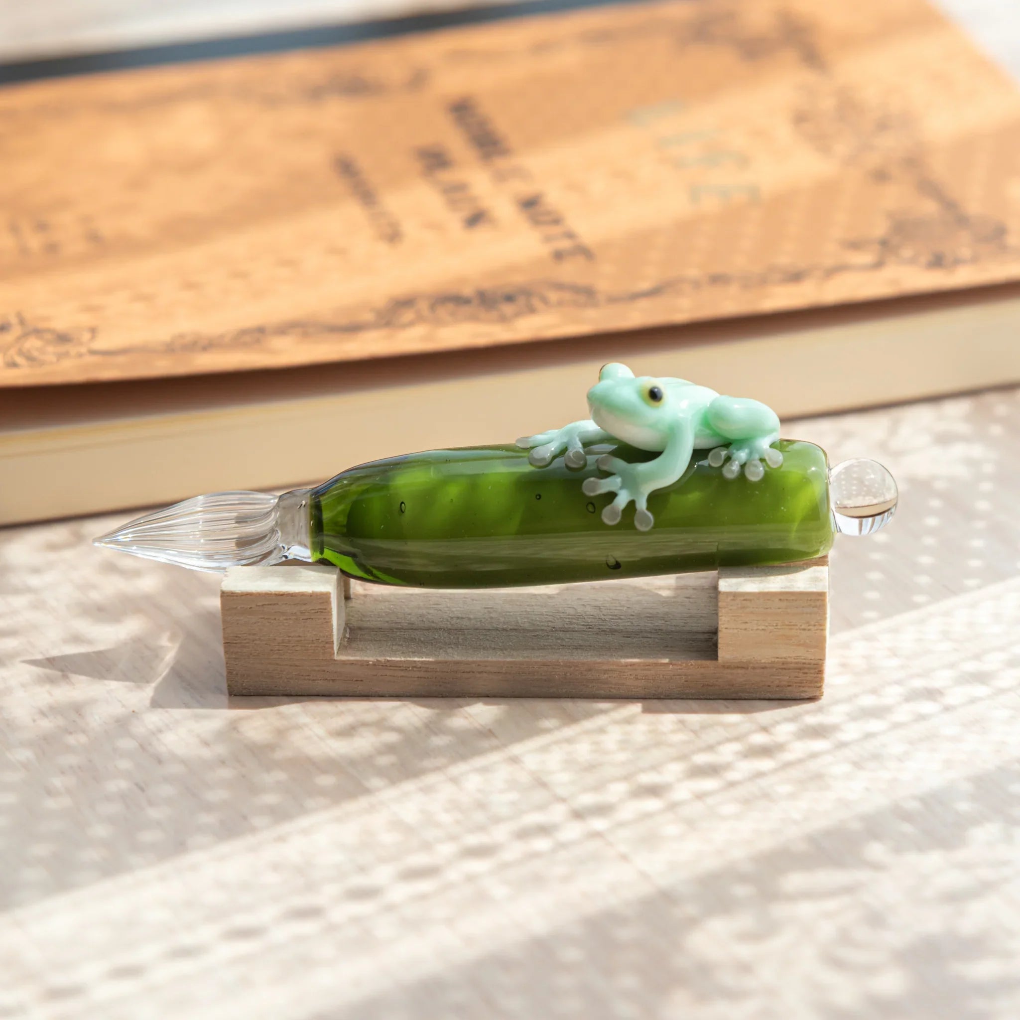 Mint frog glass dip pen with pale green resin amphibian clutching vibrant emerald hand-blown glass bottle