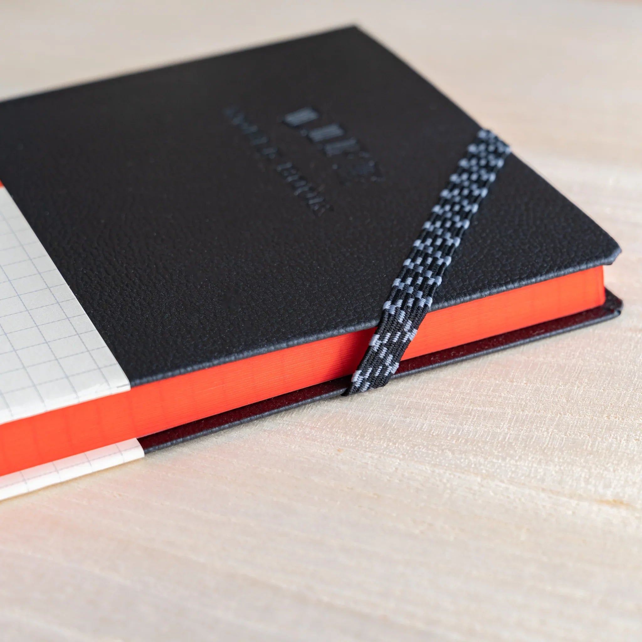 Life Noble A6 hardcover notebook, open view showing leather cover with spine visible                          