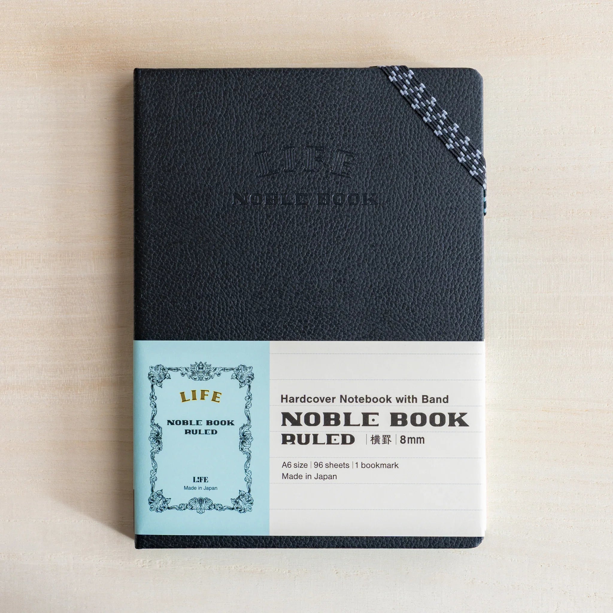 Life Noble A6 notebook, open view showing leather cover showing spine visible                                 