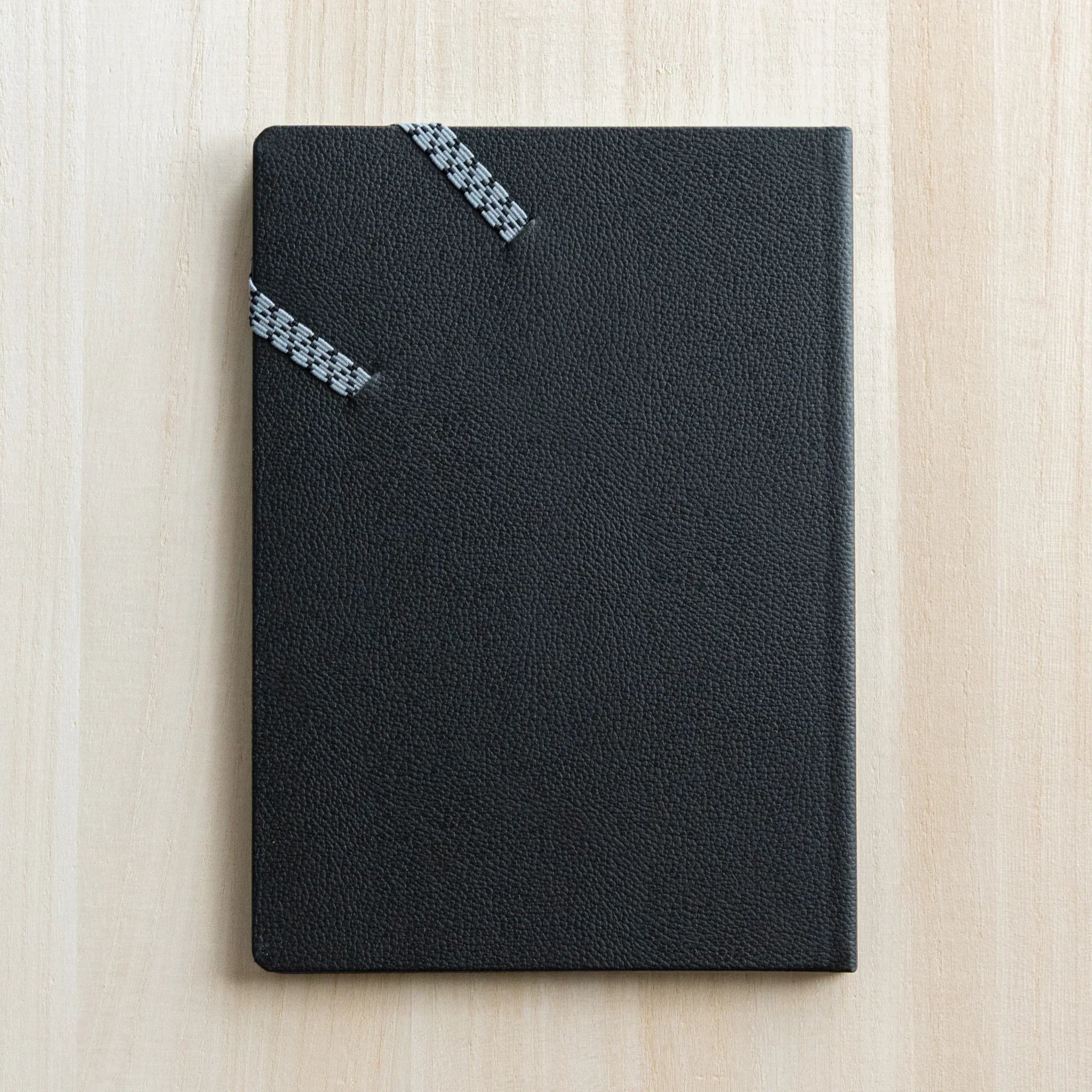 Life Noble planner for 2026 in navy leather, open showing pages with gold lettering                           