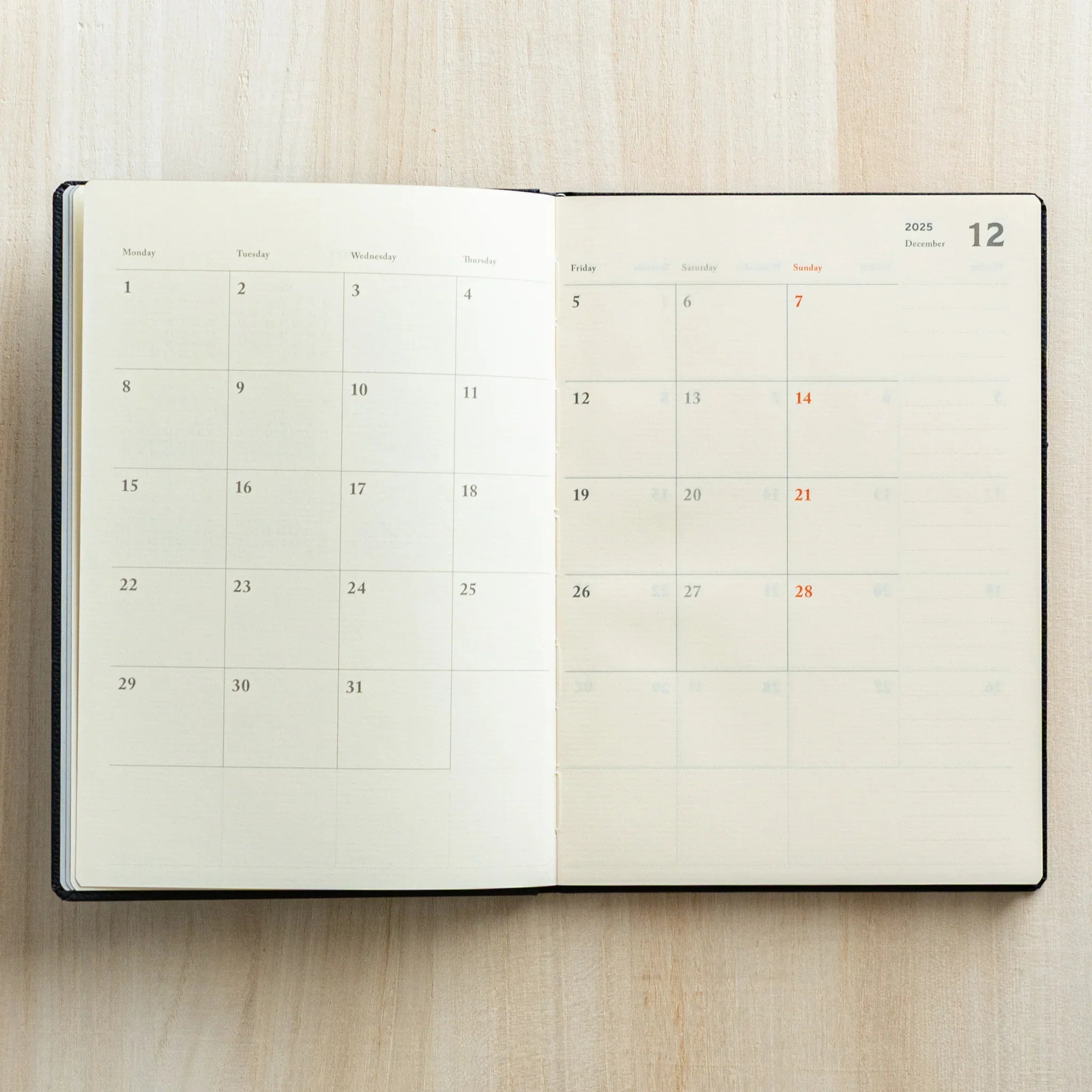 Life Noble planner for 2026, dark tone cover, open showing pages highlighting gold lettering                  