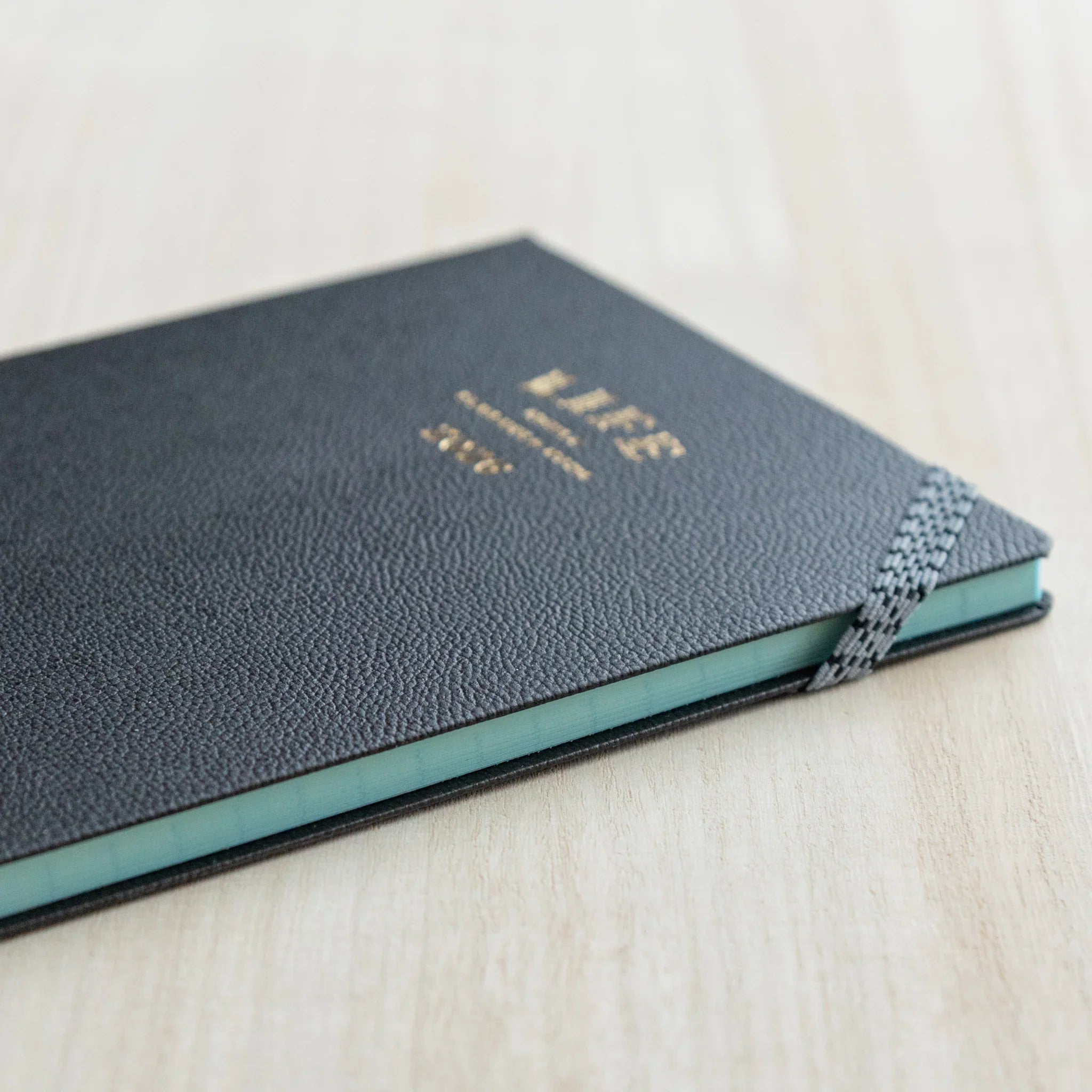 Life Noble 2026 hardcover planner featuring charcoal, product shot showing embossed text                      