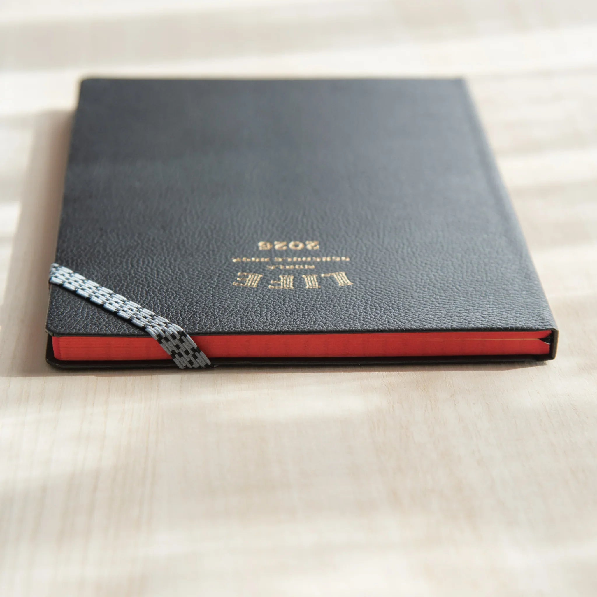 Life Noble 2026 hardcover planner, dark navy cover, front cover view highlighting gold foil embossing         