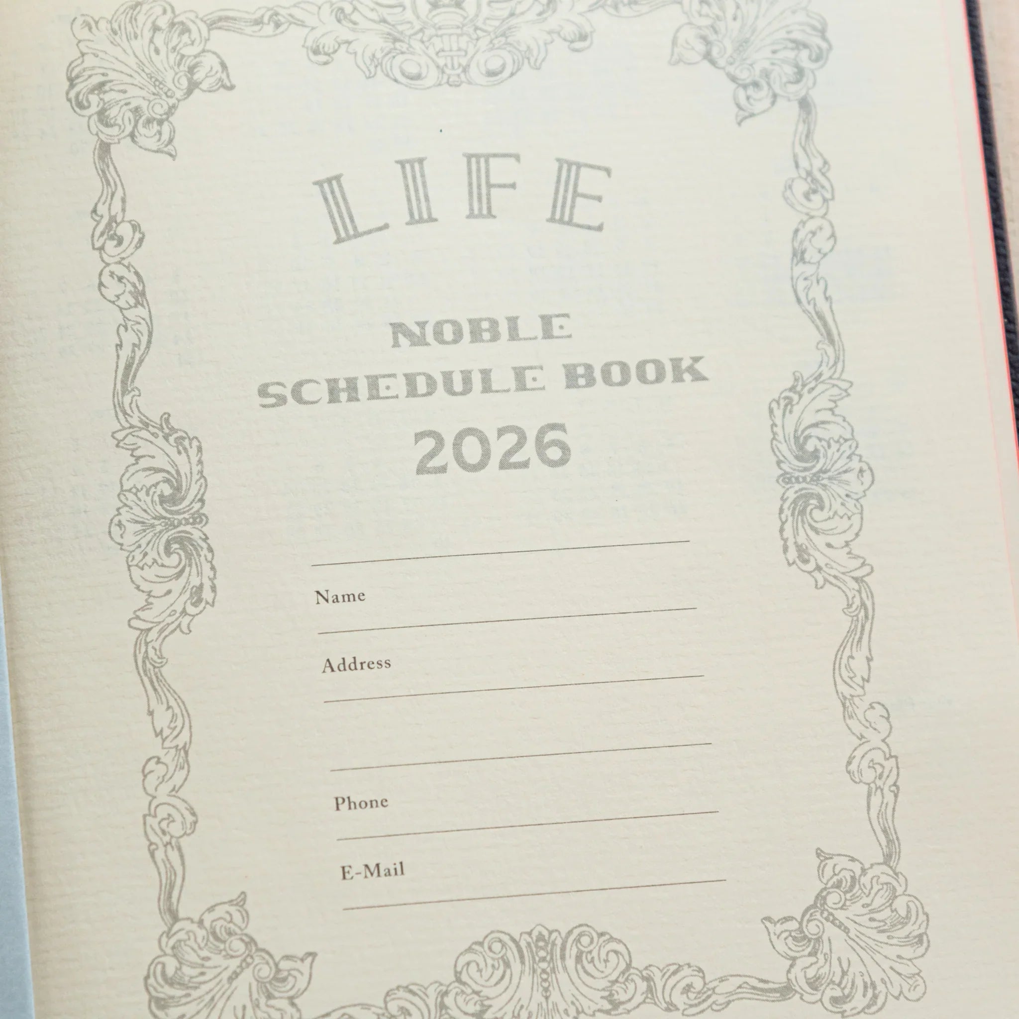 Life Noble 2026 planning notebook, dark navy cover, front cover view highlighting gold foil embossing         
