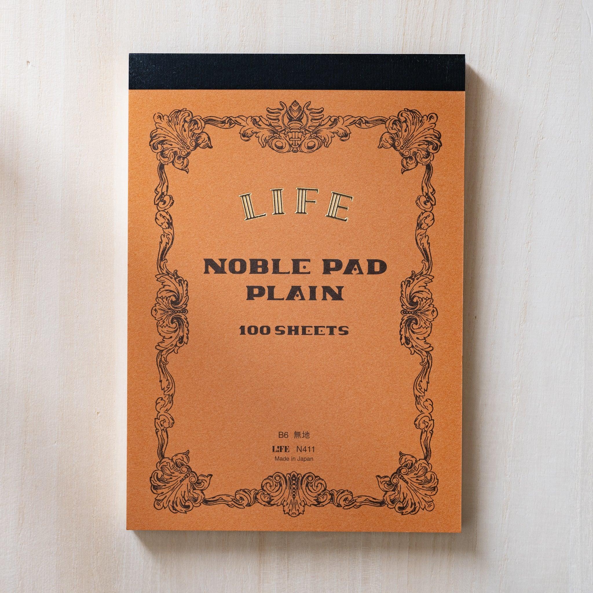 Life Noble B6 memo pad with decorative cover design, angled view showing demonstrating color options          